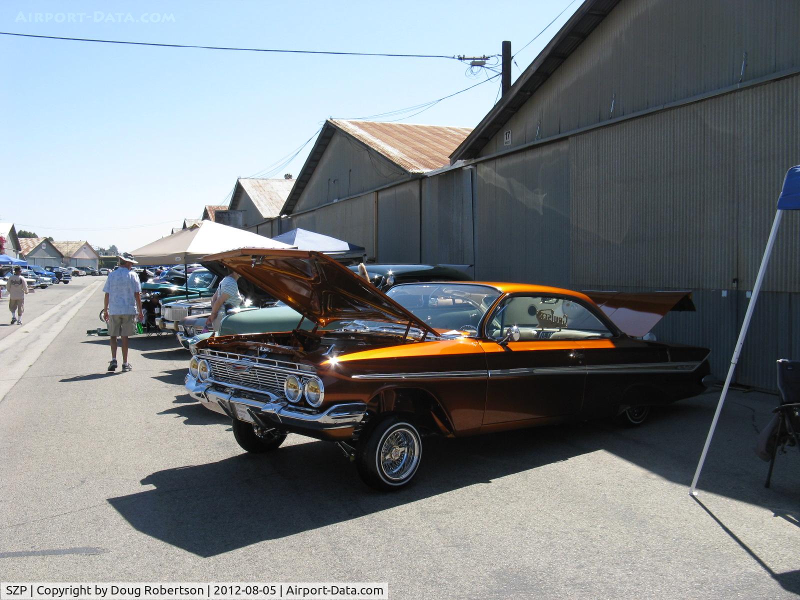 Santa Paula Airport (SZP) - First Sunday Aviation Museum of Santa Paula Open House & Fly-In invites car clubs-this is a Chevrolet hardtop coupe half-jacked with chromed hydraulics located in open trunk.