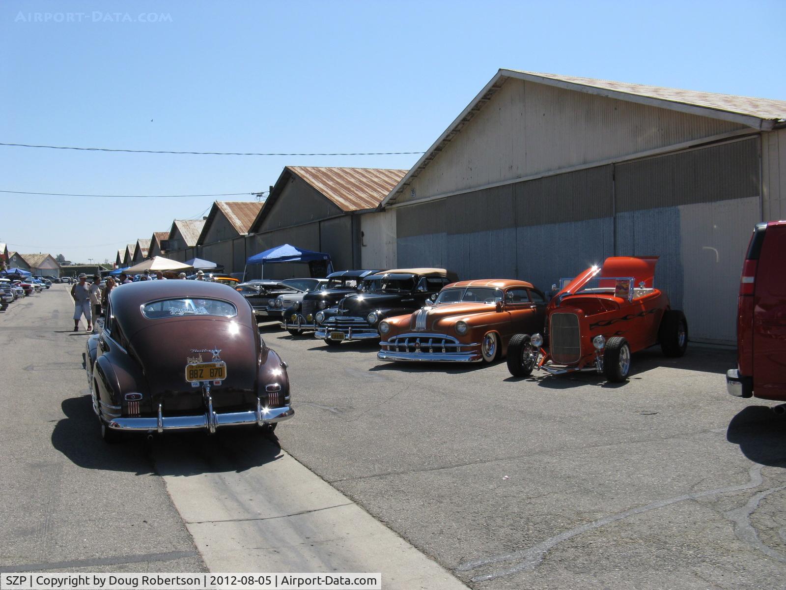 Santa Paula Airport (SZP) - First Sunday Aviation Museum of Santa Paula Open House & Fly-In invites car clubs-four rows of hangars blocked with old restored, custom cars by permission.