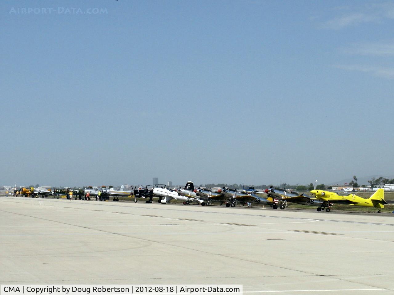 Camarillo Airport (CMA) - 2012 Wings Over Camarillo Airshow, some featured airshow aircraft on the ready ramp including Rob Harrison's N666XC yellow ZLIN 'Tumbling Bear' on the right