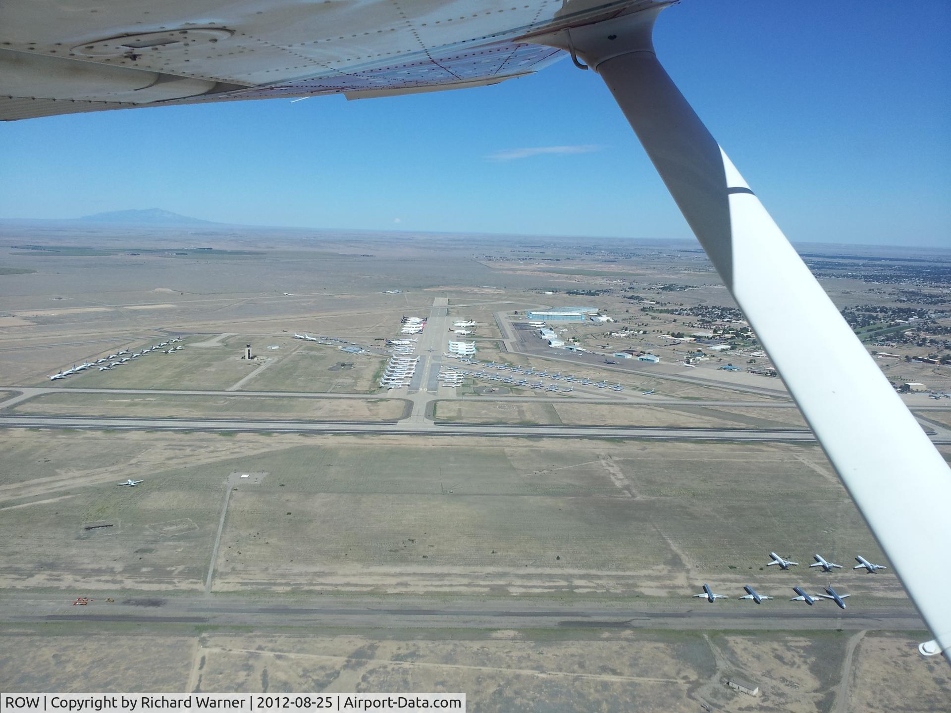 Roswell International Air Center Airport (ROW) - From a point 2 miles SE of the Roswell International Air Air Center Airport at approximately 1,000' AGL looking northwest, about 125 aircraft are visible on the tarmac.