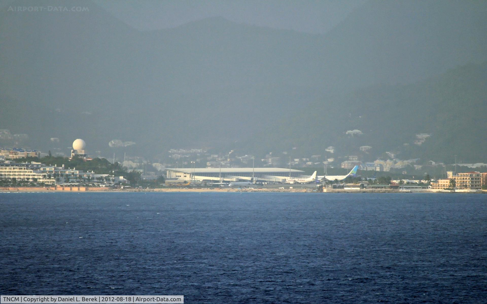 Princess Juliana International Airport, Philipsburg, Sint Maarten Netherlands Antilles (TNCM) - This is what SXM looks like from way out at sea; the famous Maho Beach from which people photograph low-flying aircraft is visible.