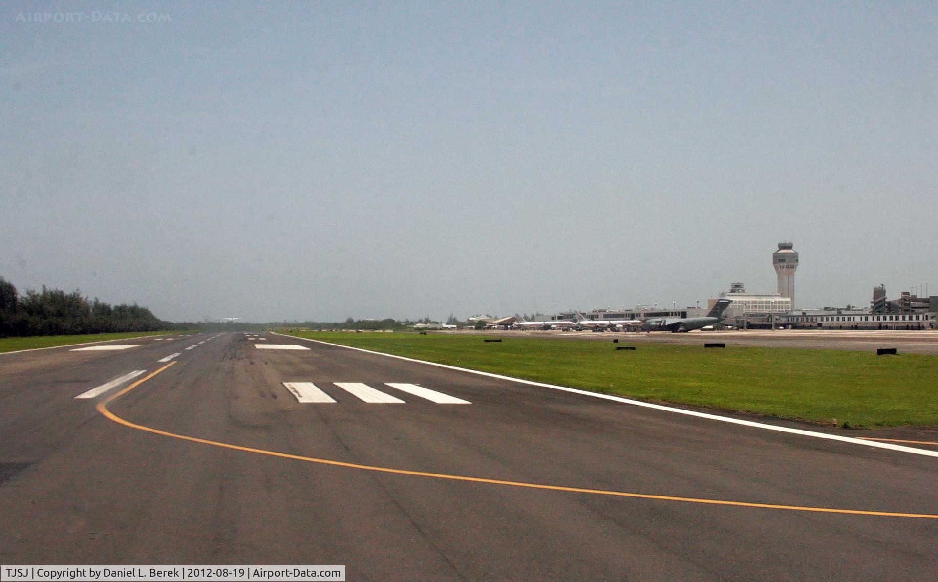 Luis Muñoz Marín International Airport, San Juan Puerto Rico (TJSJ) - This is a view of the northern side of SJU, at the threshold of Runway 8L.  I was surprised to see the C-17, as there is a military depot to the east.