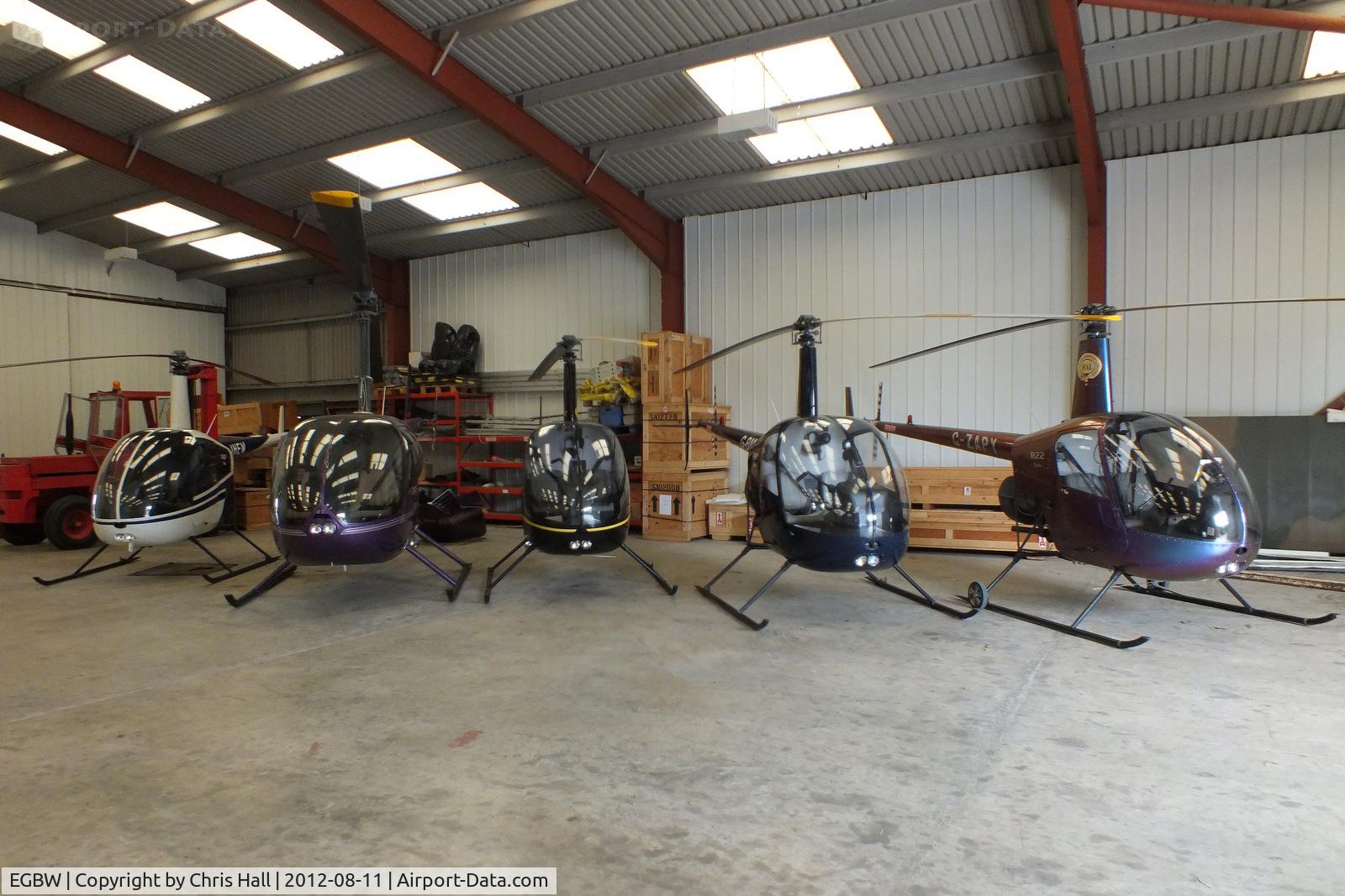 Wellesbourne Mountford Airfield Airport, Wellesbourne, England United Kingdom (EGBW) - from L to R G-JHEW, G-RUZZ, G-OSAZ, G-BMIZ and G-ZAPY inside the Heli Air hangar
