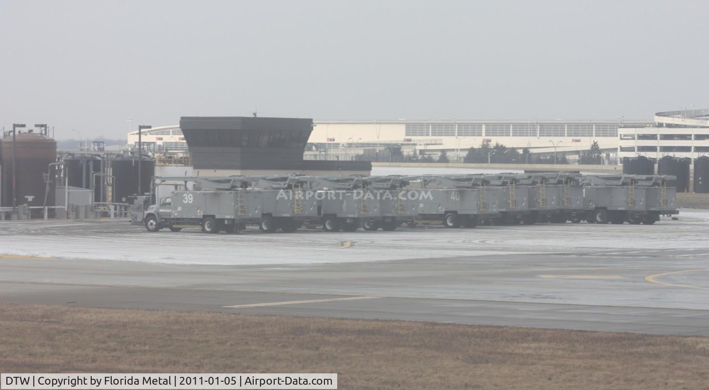Detroit Metropolitan Wayne County Airport (DTW) - De-icing vehicles all lined up on the ramp