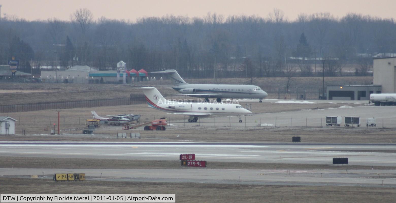 Detroit Metropolitan Wayne County Airport (DTW) - Across the ramp - Little Caesars Gulfstream II, former Detroit Pistons DC-9s, an O-2 that doesn't look flyable and a Cessna 172 - oh yeah and behind that 