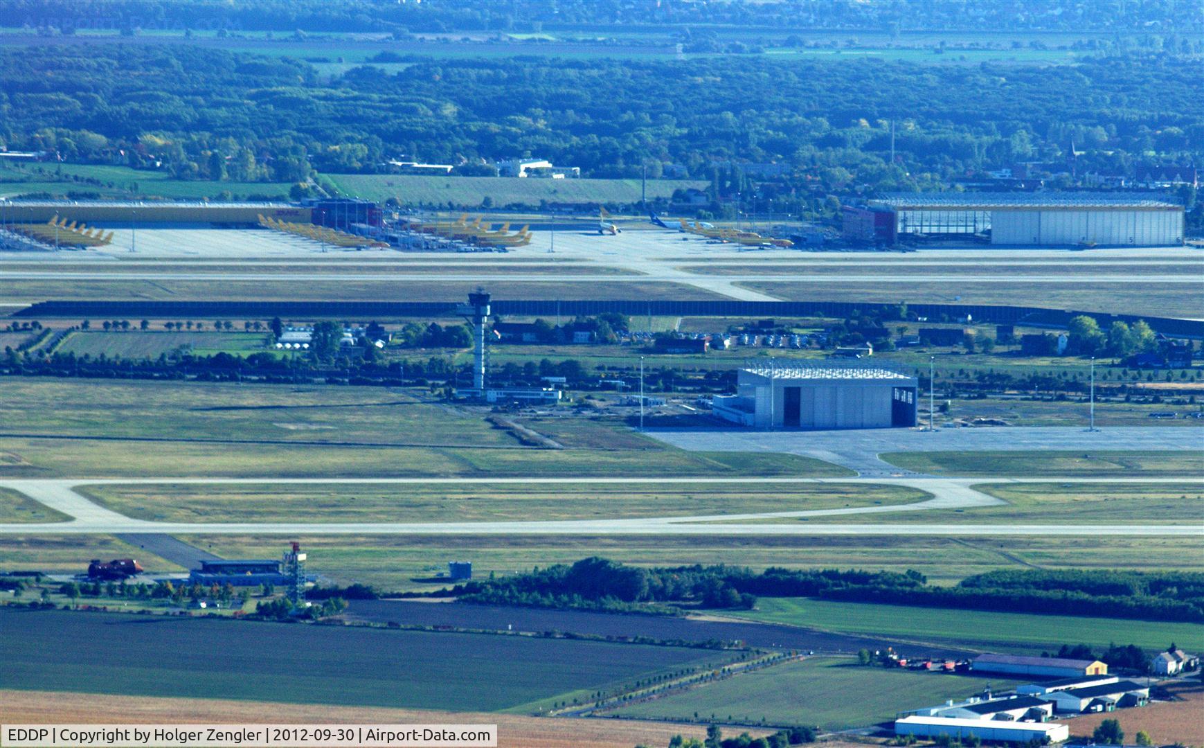 Leipzig/Halle Airport, Leipzig/Halle Germany (EDDP) - Overview of Leipzig/Halle Airport on a sunday afternoon,

left below: old radar tower and fire training range, middle: runway 26R/08L, tower and new AN124 hangar,
above: runway 26L/08R, DHL Air Hub with aprons and hangar.