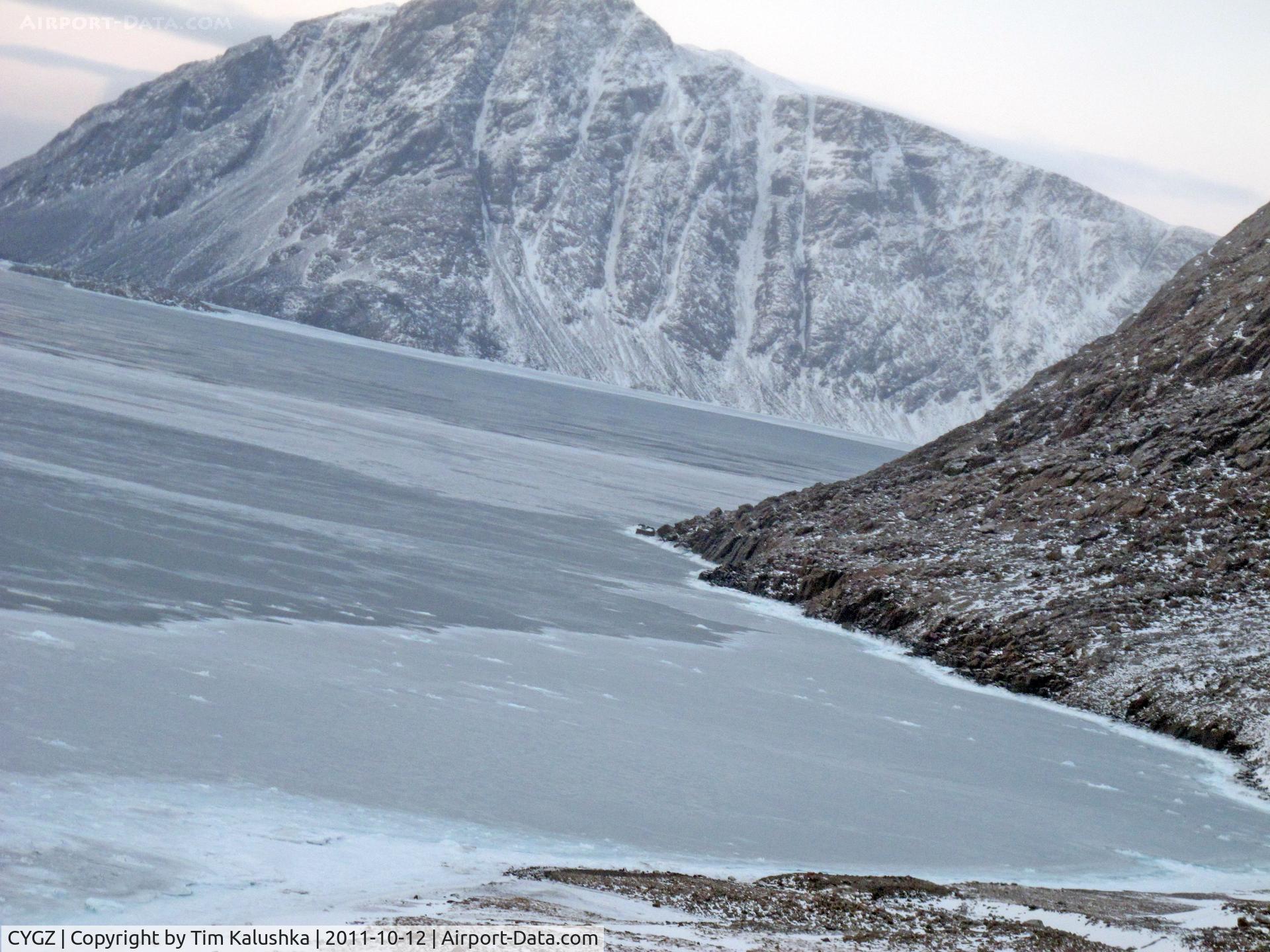 Grise Fiord Airport, Grise Fiord, Nunavut Canada (CYGZ) - In the turn to a heading of 187 True. Notice how close the mountainous terrain is.