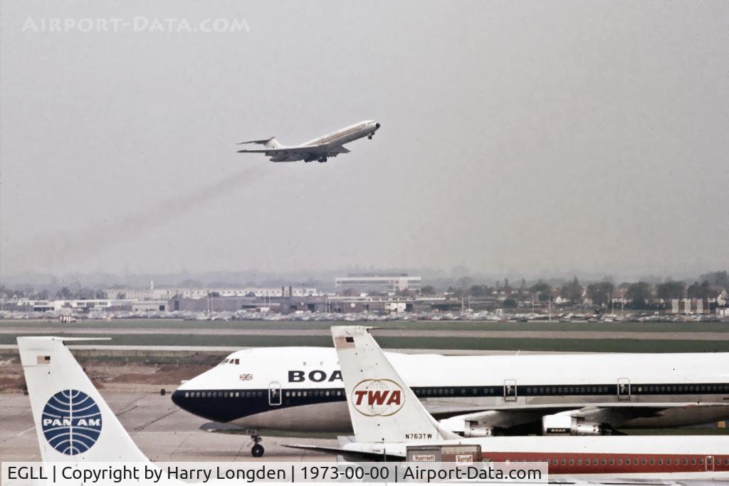 London Heathrow Airport, London, England United Kingdom (EGLL) - A view across Heathrow Airport as a VC-10 of East African Airways lifts off. In the foreground, three of the major players in the aviation industry in the 70's.