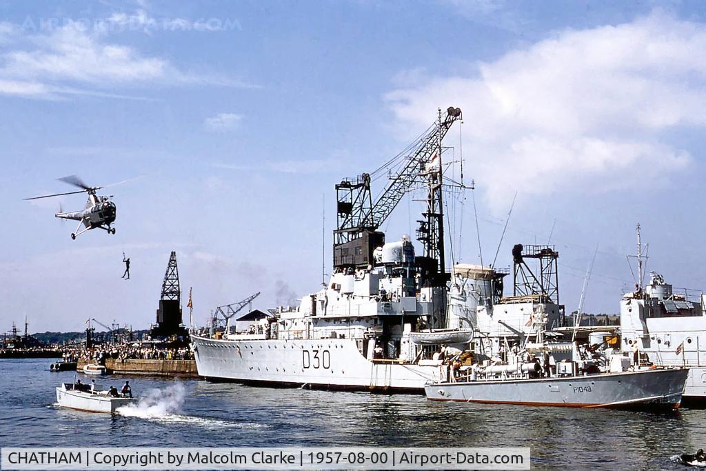 CHATHAM Airport - An unidentified Royal Navy Westland Dragonfly demonstrating alongside HMS Carron at Chatham Navy Days, August 1957 in the Royal Naval Dockyard, Chatham, UK.