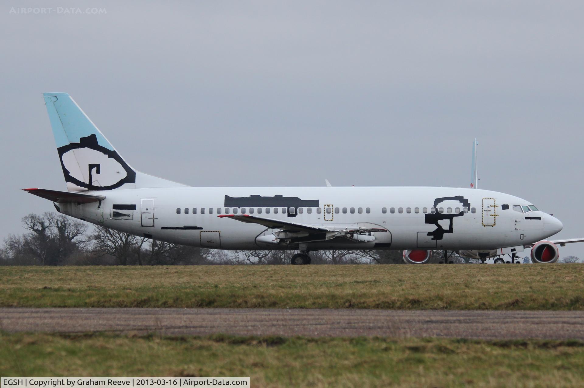 Norwich International Airport, Norwich, England United Kingdom (EGSH) - One of the former BMI Baby 737's stored at Norwich. Now with engines removed and the logo's taped over along with the registration removed.