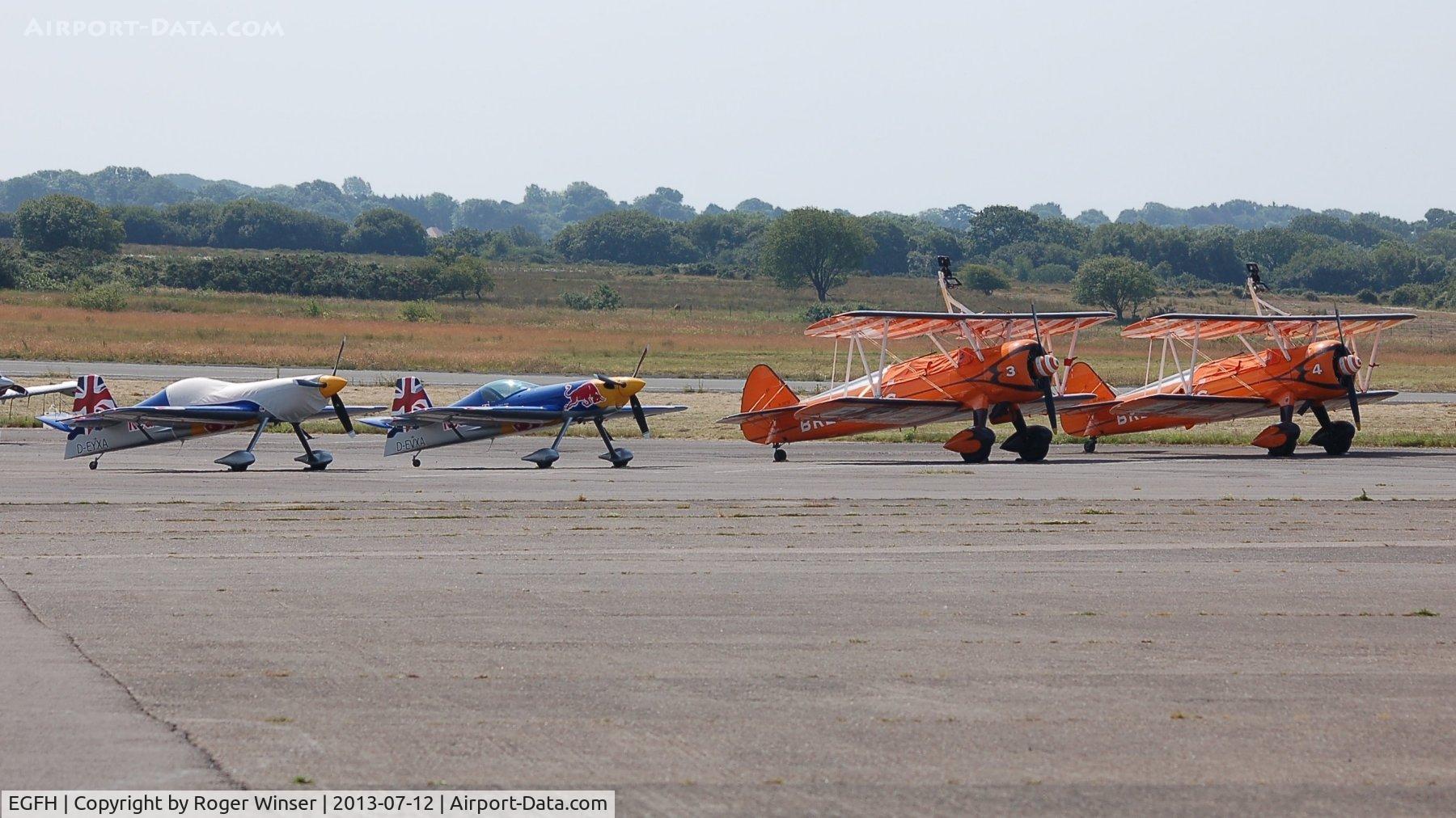 Swansea Airport, Swansea, Wales United Kingdom (EGFH) - Line up of XA-41's of the Red Bull Matadors and Boeing Stearman Kaydet biplanes of the Brietling Wingwalkers at Swansea Airport prior to displaying at the Wales National Air Show.