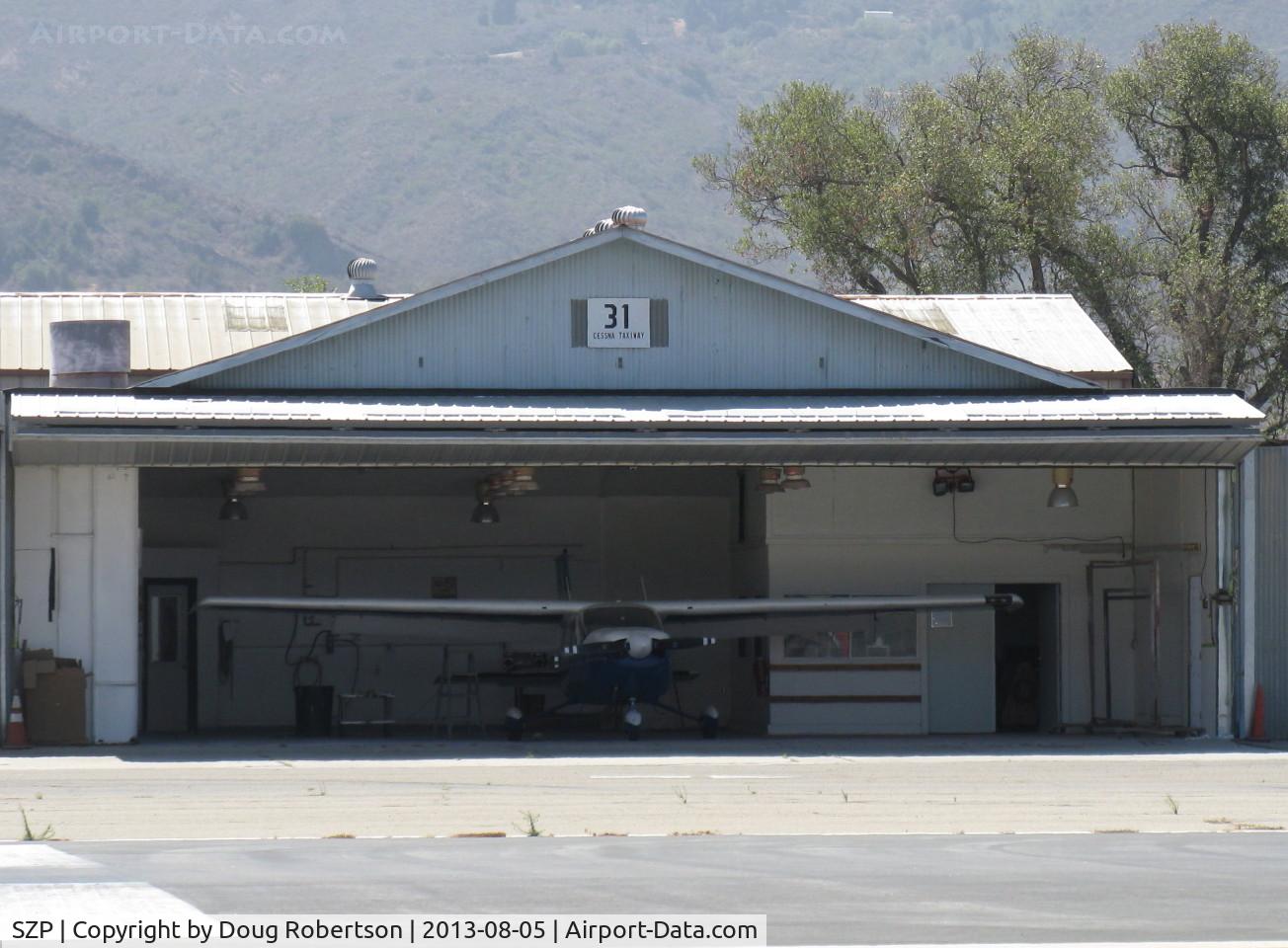 Santa Paula Airport (SZP) - 31 Cessna Taxi. Santa Paula Airport's Do-It-Yourself Paint Shop Hangar. Rarely seen with an open door.