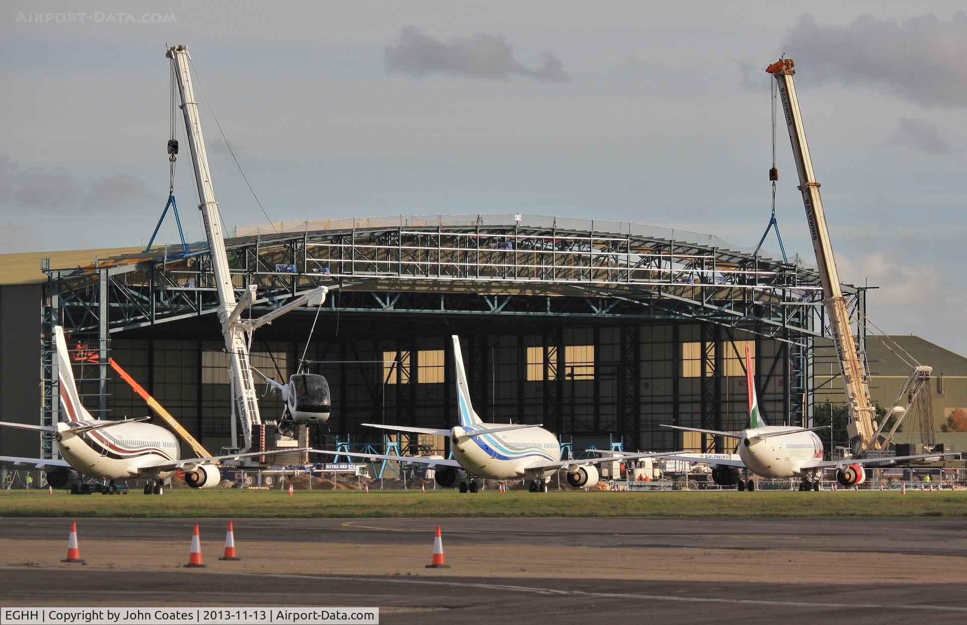 Bournemouth Airport, Bournemouth, England United Kingdom (EGHH) - Hangar extension for new B748BBJ taking shape - flyby by G-EMOL.