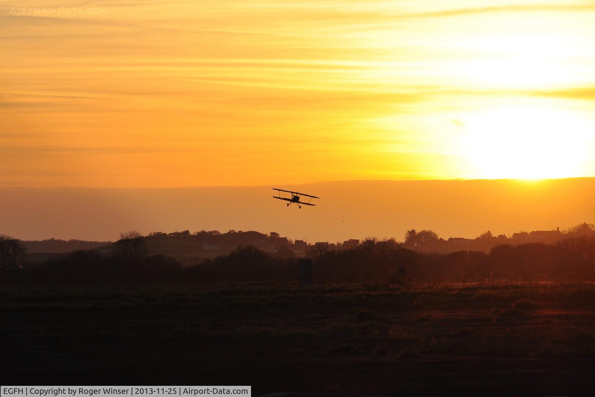 Swansea Airport, Swansea, Wales United Kingdom (EGFH) - Biplane arriving at sunset.