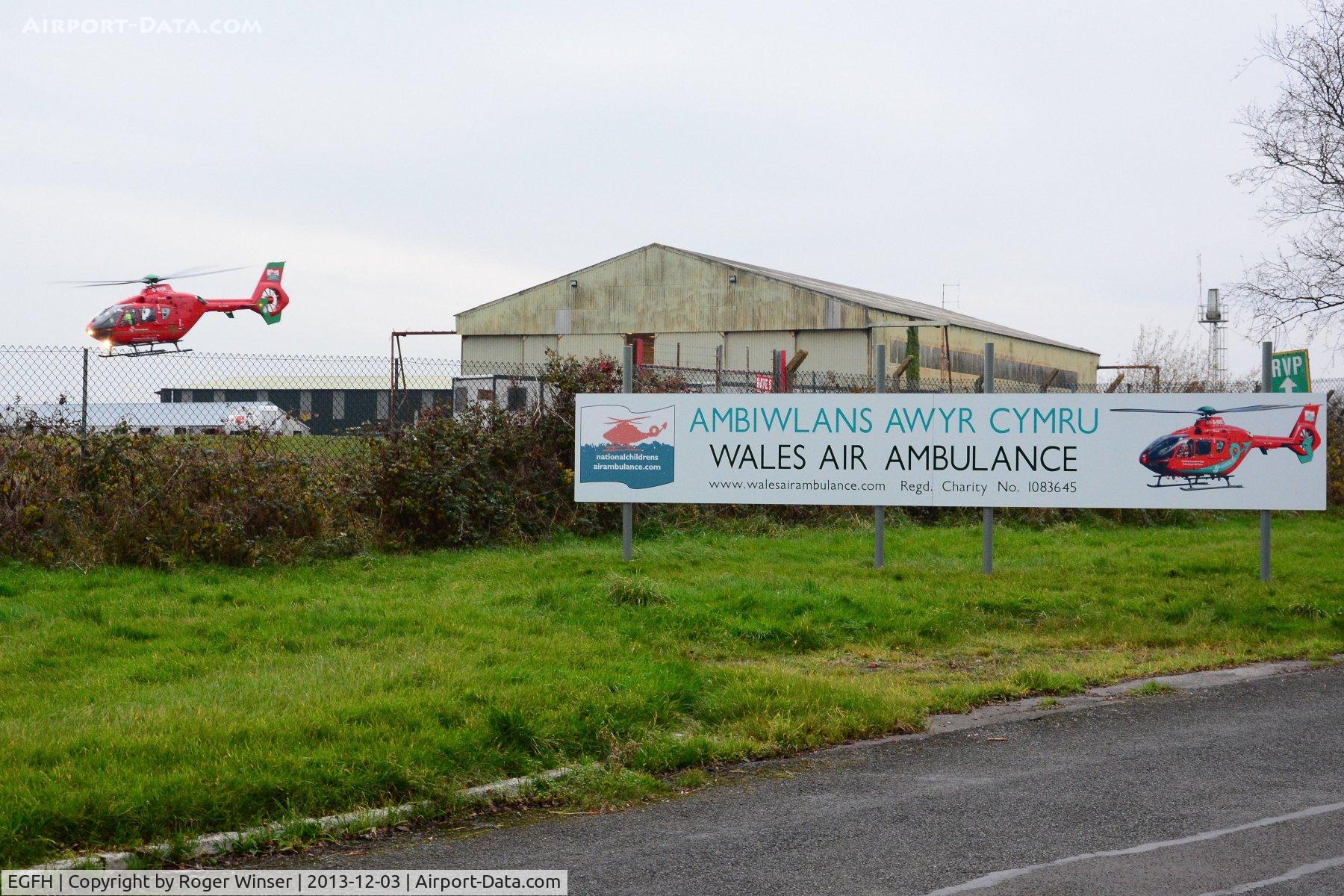 Swansea Airport, Swansea, Wales United Kingdom (EGFH) - Wales Air Ambulance helicopter (Helimed 57) leaving base responding to an emergency.