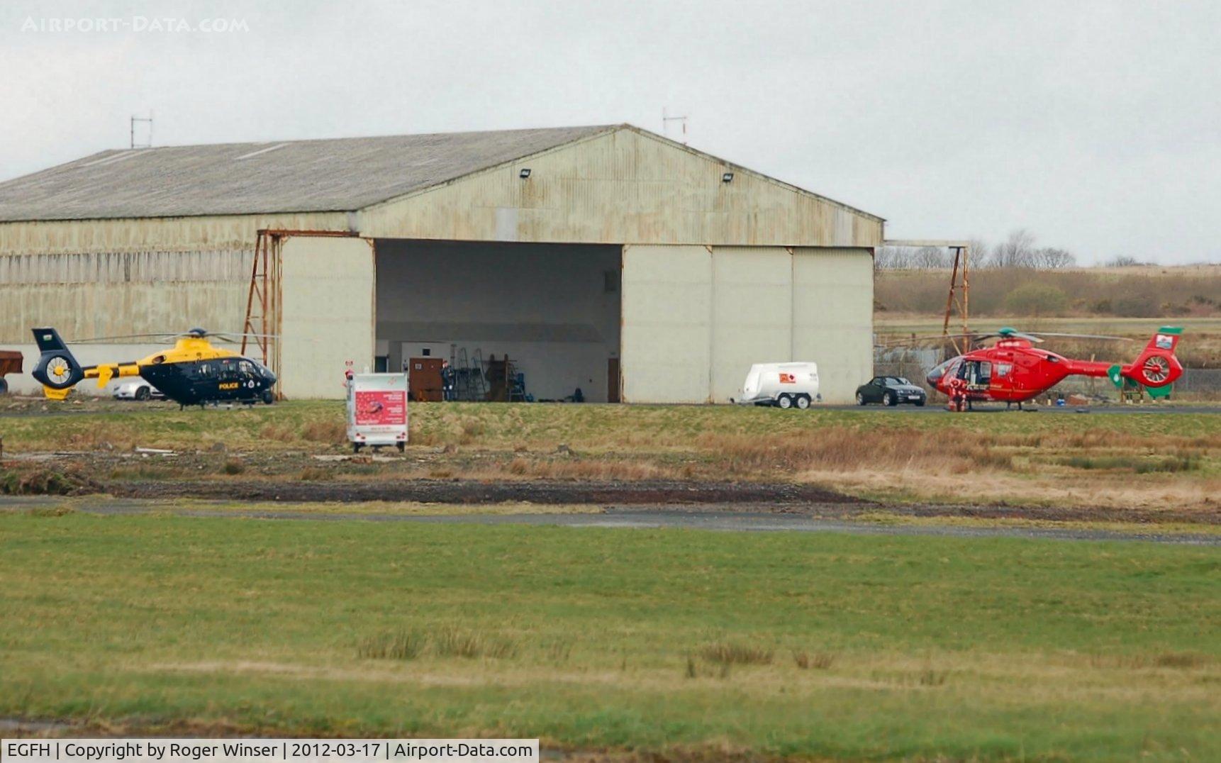 Swansea Airport, Swansea, Wales United Kingdom (EGFH) - South and East Wales Police Air Support Unit helicopter (Police 32) visiting the South Wales Air Ambulance helicopter base. The police helicopter takes over from the air ambulance helicopter (Helimed 57) at night.