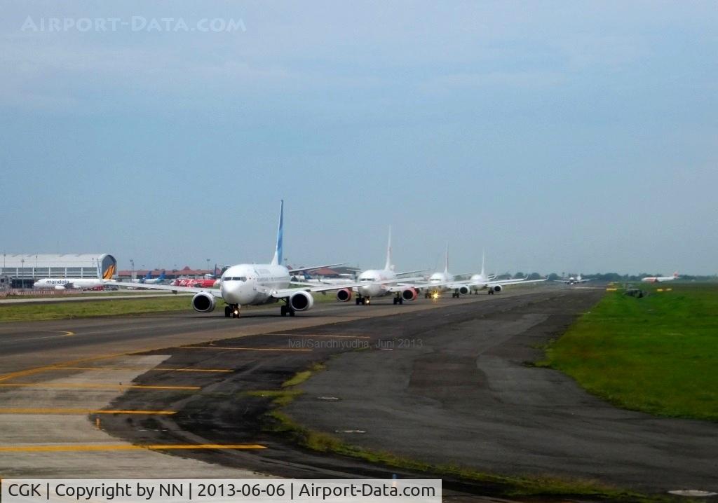 Soekarno-Hatta International Airport, Cengkareng, Banten (near Jakarta) Indonesia (CGK) - Aircrafts queue on taxiway at SOEKARNO-HATTA International Airport Jakarta. In 2012 / 2013 CGK has ranked 9th bussiest airport in the world (link : http://www.world-airport-codes.com/world-top-30-airports.html  )