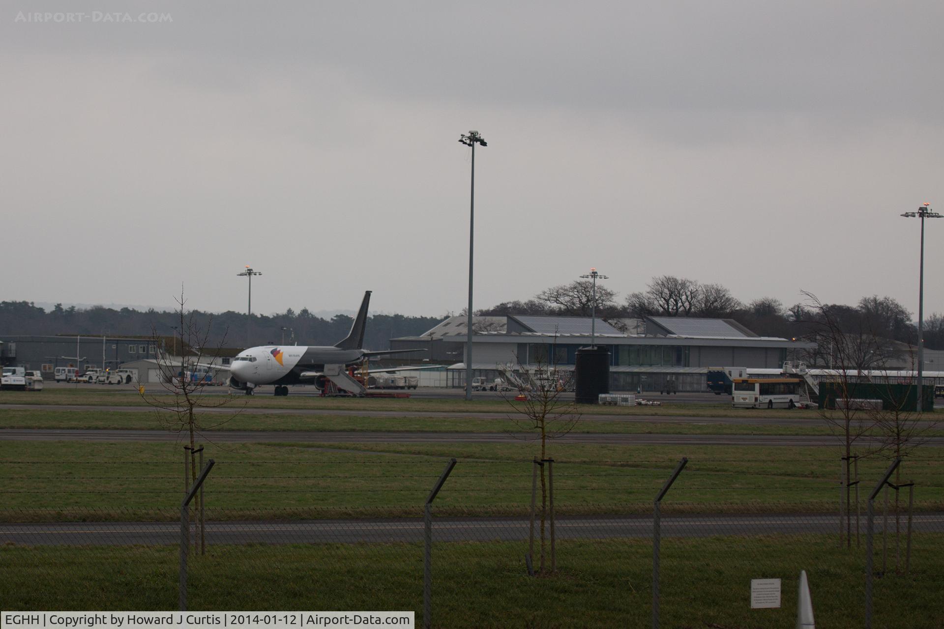Bournemouth Airport, Bournemouth, England United Kingdom (EGHH) - A dark January afternoon. The Northern apron with 737 G-JMCT parked up.