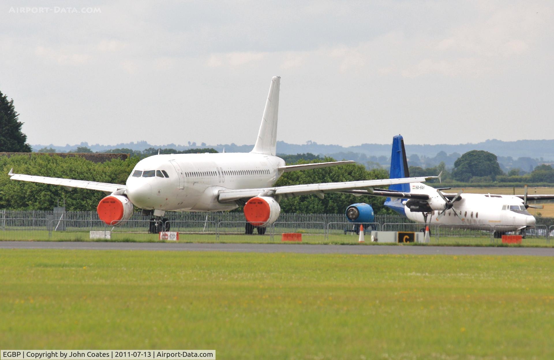 Kemble Airport, Kemble, England United Kingdom (EGBP) - Storage area with HA-FAH and un-reg'd A320