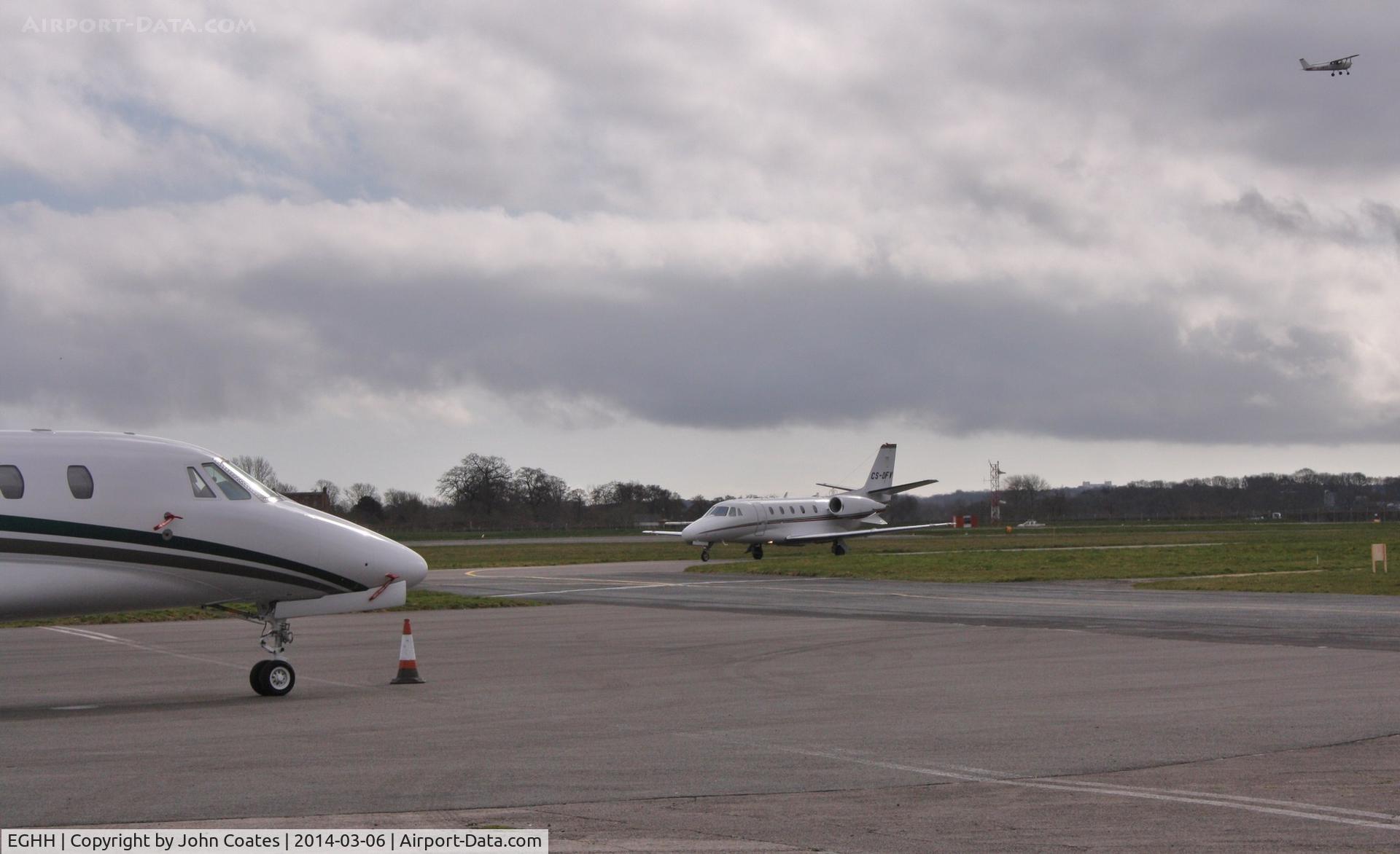 Bournemouth Airport, Bournemouth, England United Kingdom (EGHH) - View from Citation Centre with CS-DFV arriving to join M-IMOR and G-AWOT departing behind.