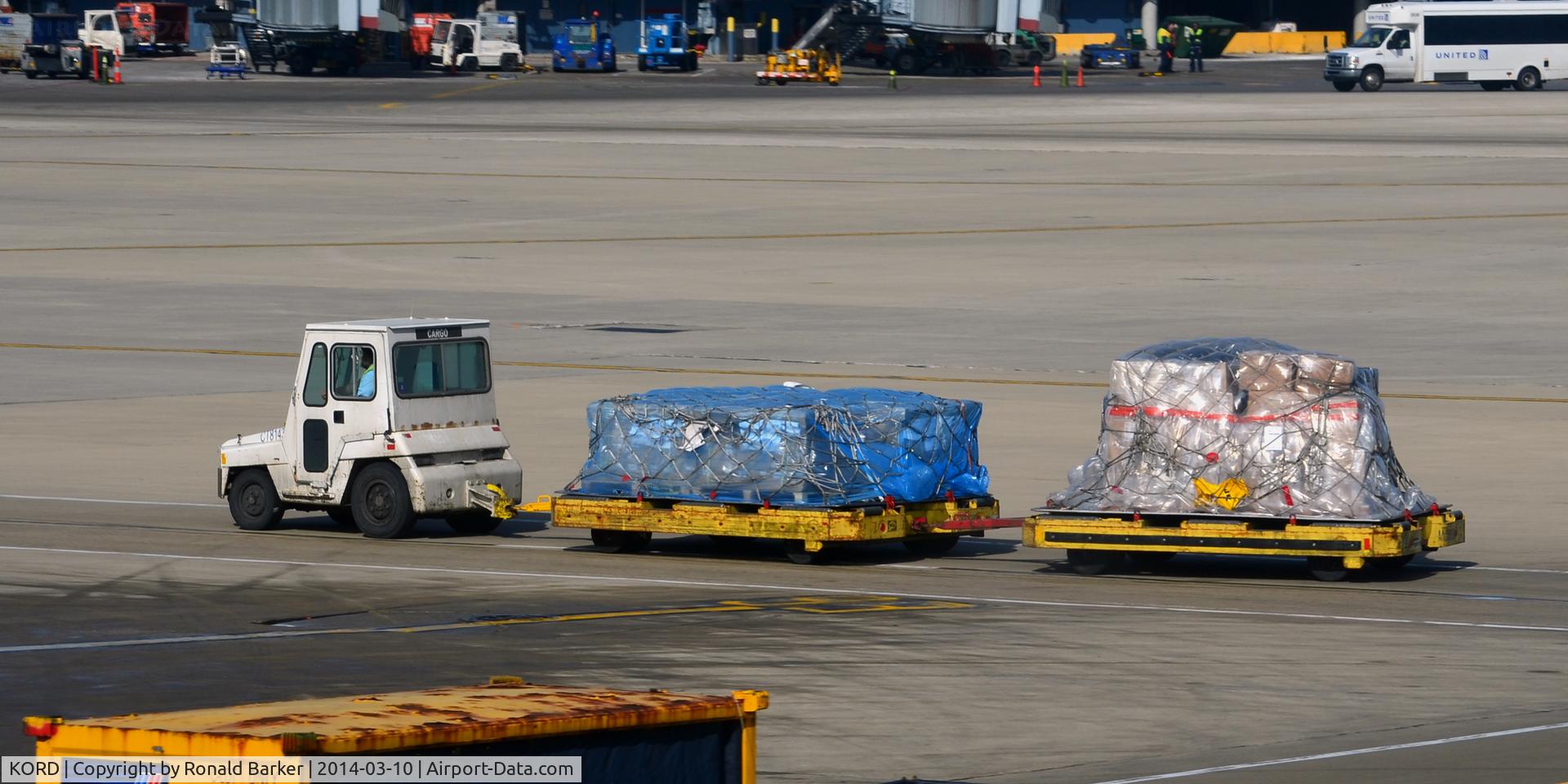 Chicago O'hare International Airport (ORD) - Baggage cart towed on the  ramp at O'Hare