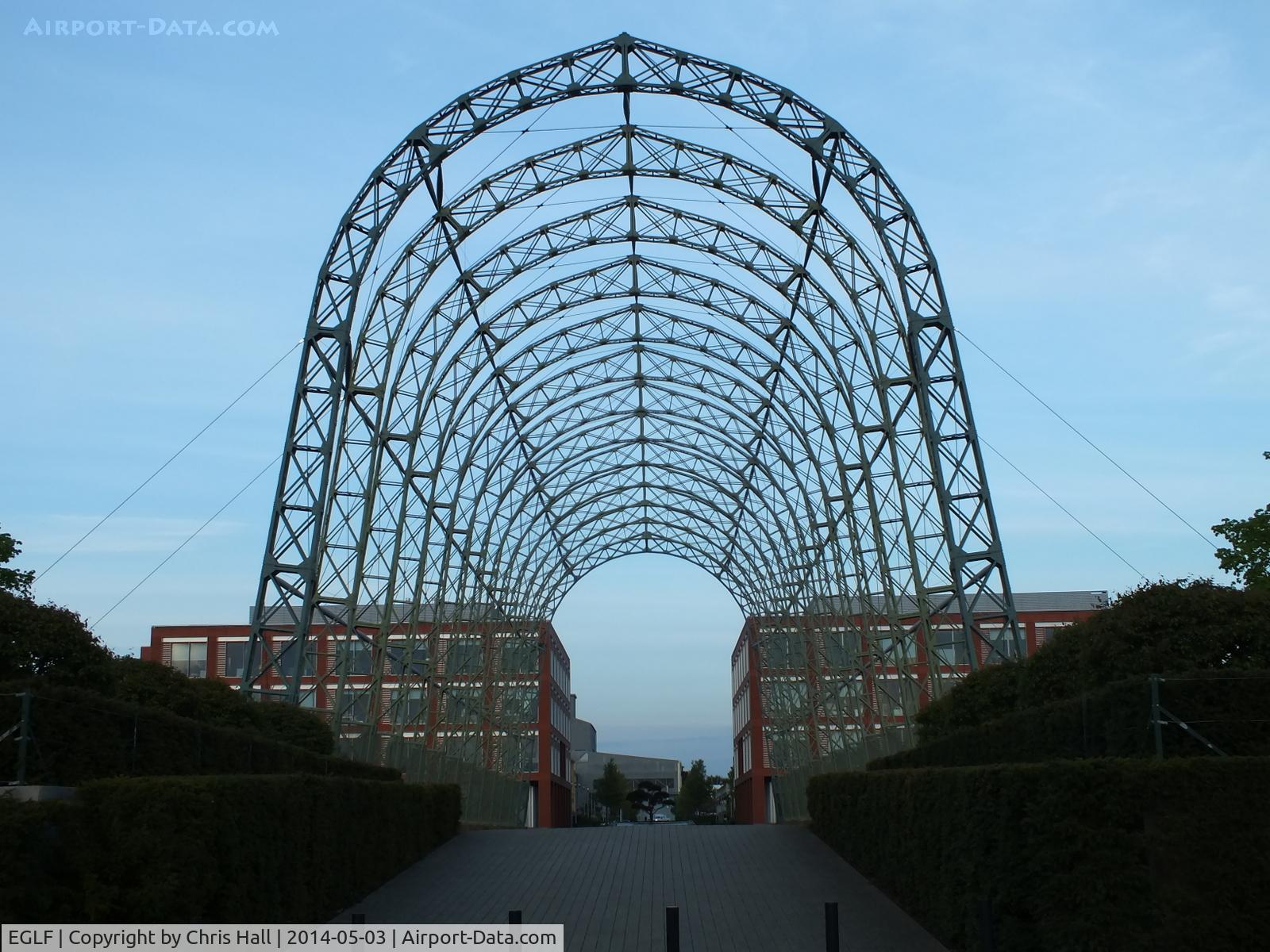 Farnborough Airfield Airport, Farnborough, England United Kingdom (EGLF) - The 260-foot long Portable Airship Hangar made up of 112 riveted lattice frames and bolted together to form the 70ft high structure. It is the centrepiece of the new business park that now occupies part of the former Farnborough Airfield site.