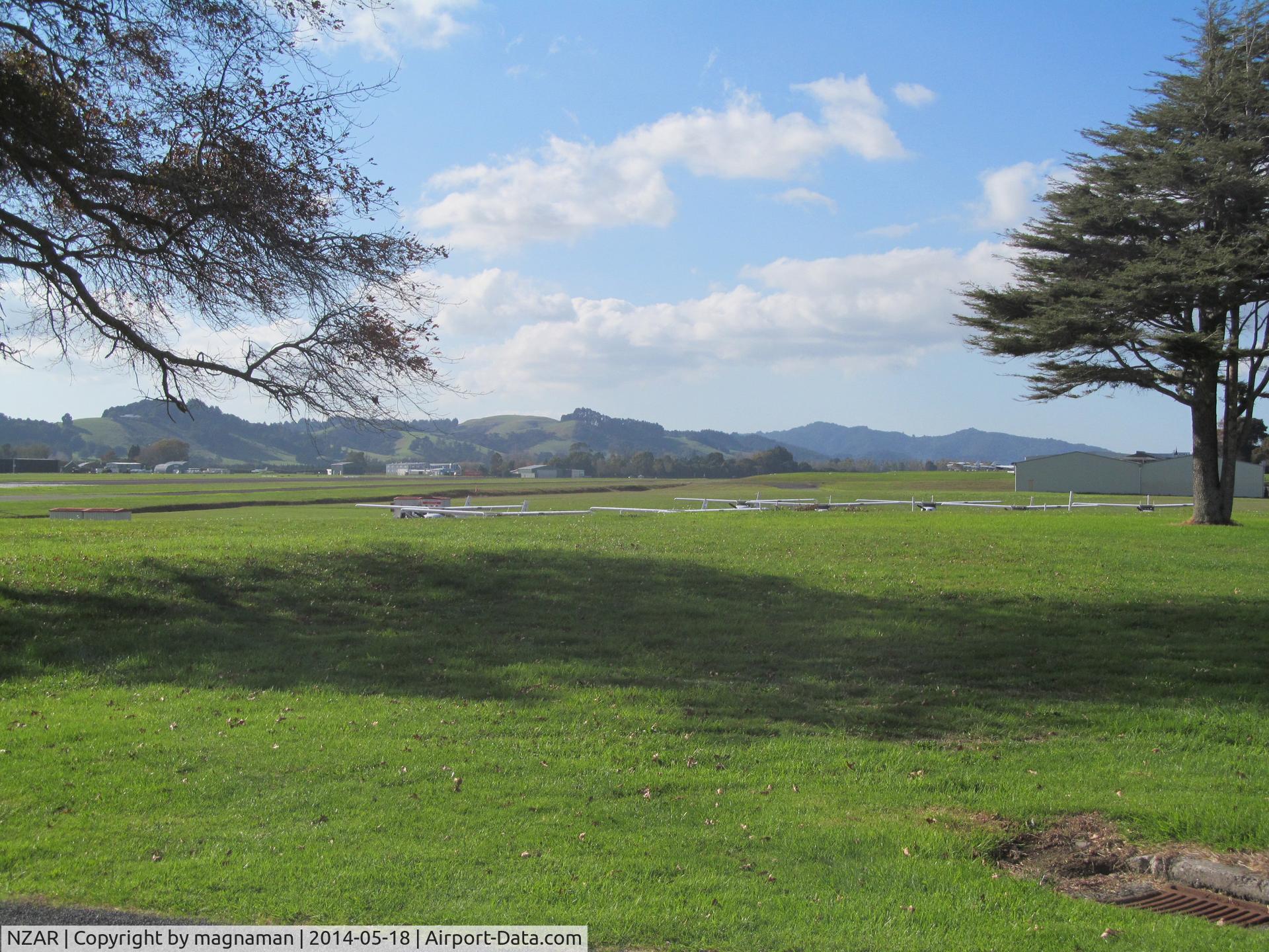 Ardmore Airport, Auckland New Zealand (NZAR) - Flying club Cessna squadron wings just visible over the grassy knoll. A great little airfield which is a pleasure to visit when it is sunny.