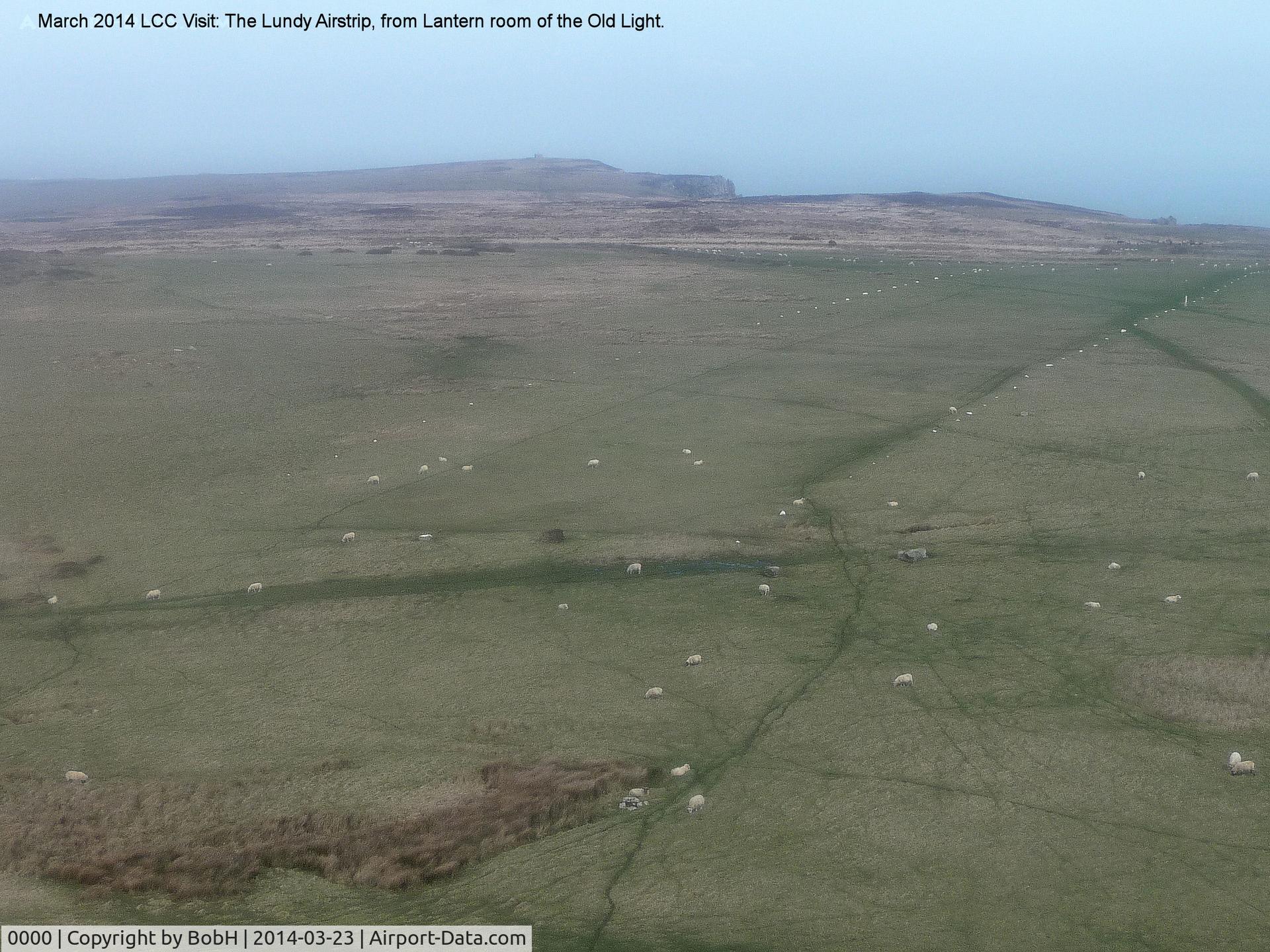 0000 Airport - The Airstrip on Lundy Island. The width is marked with white painted stones. 99% of the time a strong westerly blows and here you are looking East. The other white objects are sheep! Approach very carefully. Lundy is 11 miles off North Devon Coast.