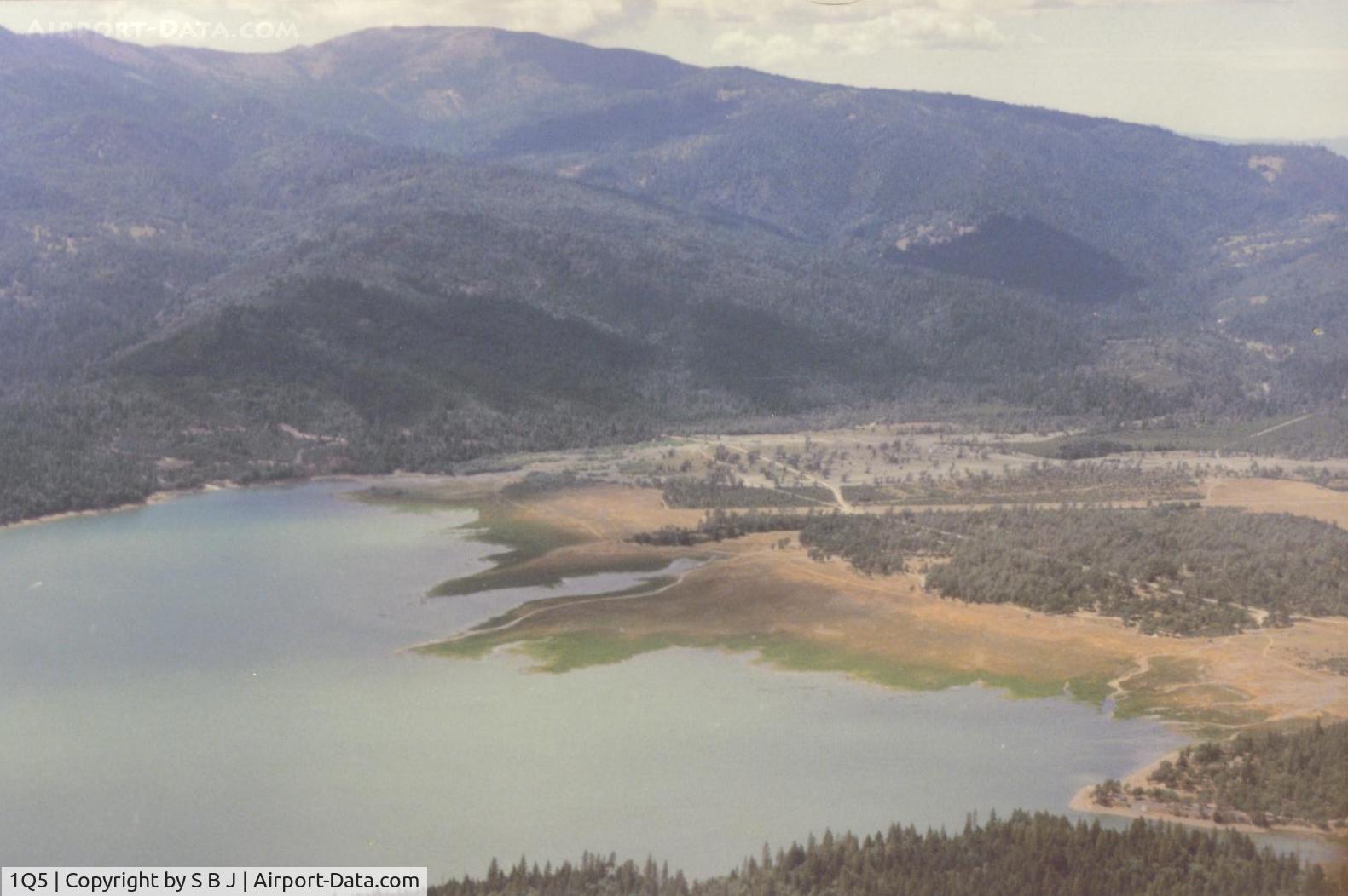 Gravelly Valley Airport (1Q5) - Lake Pillsbury looking west. Because of the mountainous terrain,1Q5 is not pilot friendly when windy. A 25 kt wind contributed to a fatal C172 accident on 5-8-82. At one time there was a cross wind runway which could have helped this unfortunate pilot.