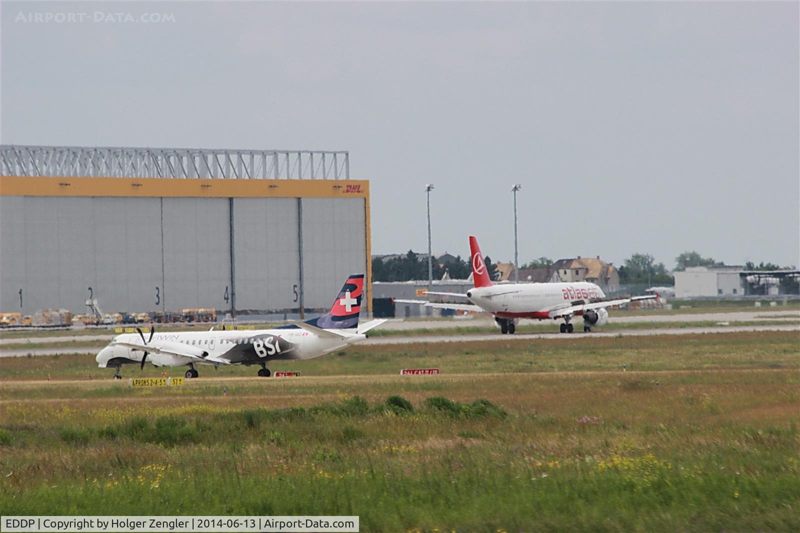 Leipzig/Halle Airport, Leipzig/Halle Germany (EDDP) - Inbound traffic on rwy 25L observed by taxiing twin engined aircraft at holding point....