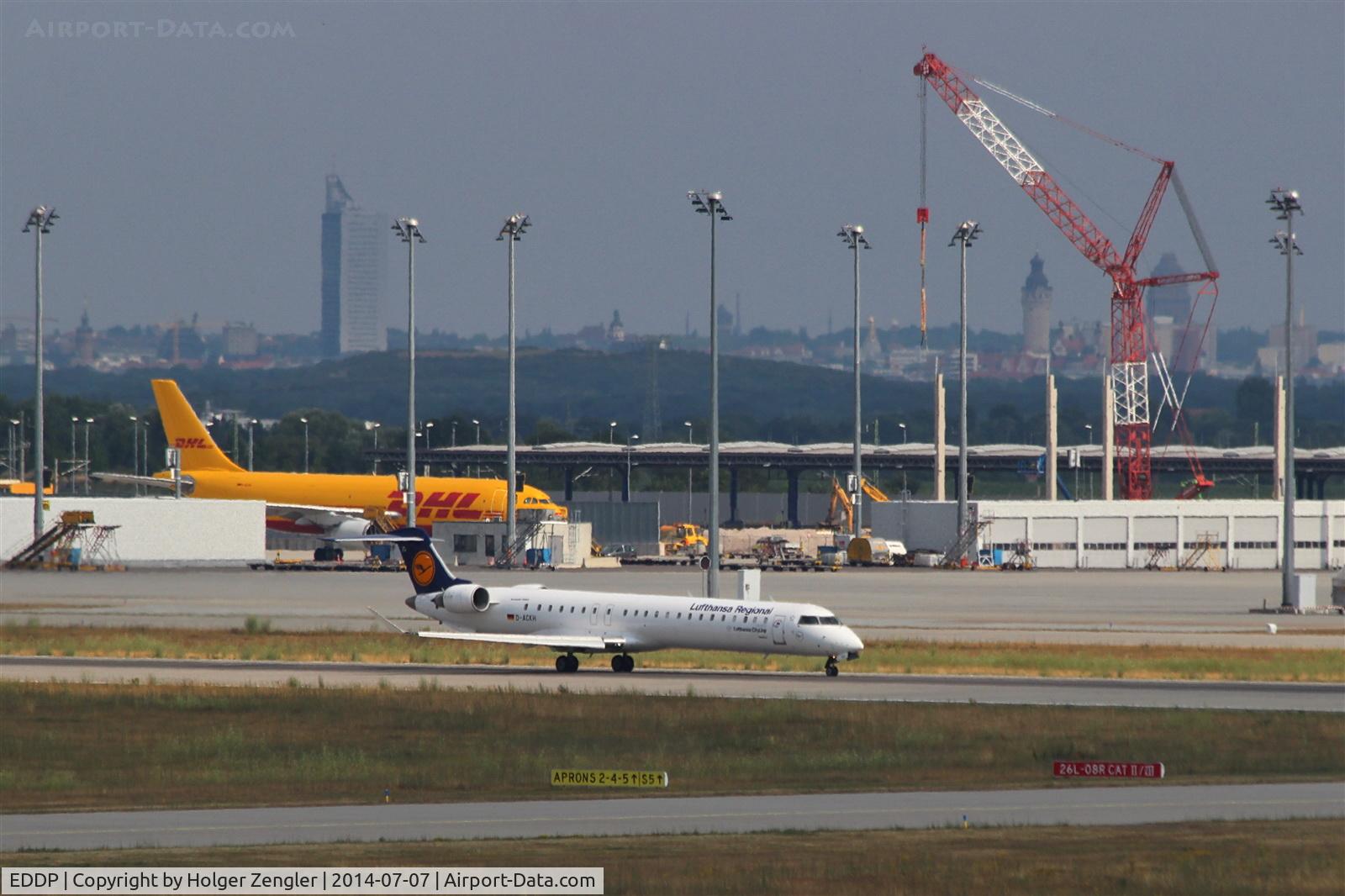 Leipzig/Halle Airport, Leipzig/Halle Germany (EDDP) - View from old tower to outbound traffic on rwy 26L, in background apron 4, new DHL hall in being and city of Leipzig in pretty afternoon light.