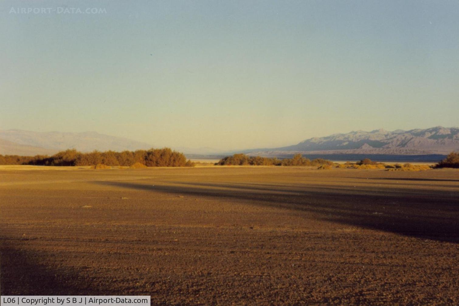 Furnace Creek Airport (L06) - View from the tiedown area toward the  runway and to the NW. Visibility is often unlimited.Frist time flying into D V,pilots will be amused to see the altimeter go below zero by some 200 feet and a 600 ft pattern (altimeter) is in order.