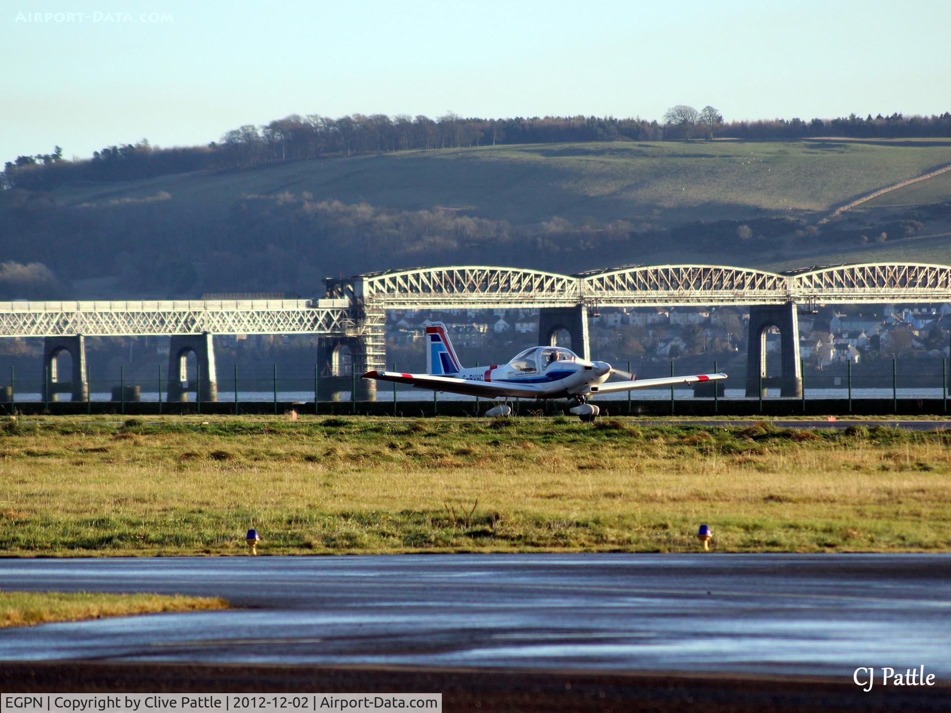 Dundee Airport, Dundee, Scotland United Kingdom (EGPN) - With a backdrop of the Tay Rail Bridge, a Grob Heron of the based Tayside Aviation prepares to take off.
