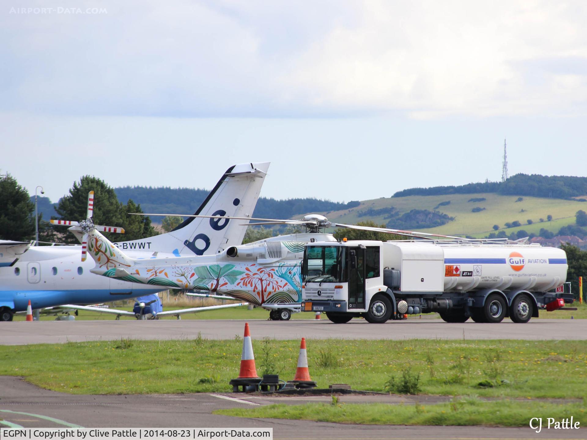 Dundee Airport, Dundee, Scotland United Kingdom (EGPN) - Refueling action at Dundee Riverside. Helicopter is visiting AW139 ZS-EOS with Flybe Dornier 328 G-BWWT in the rear.