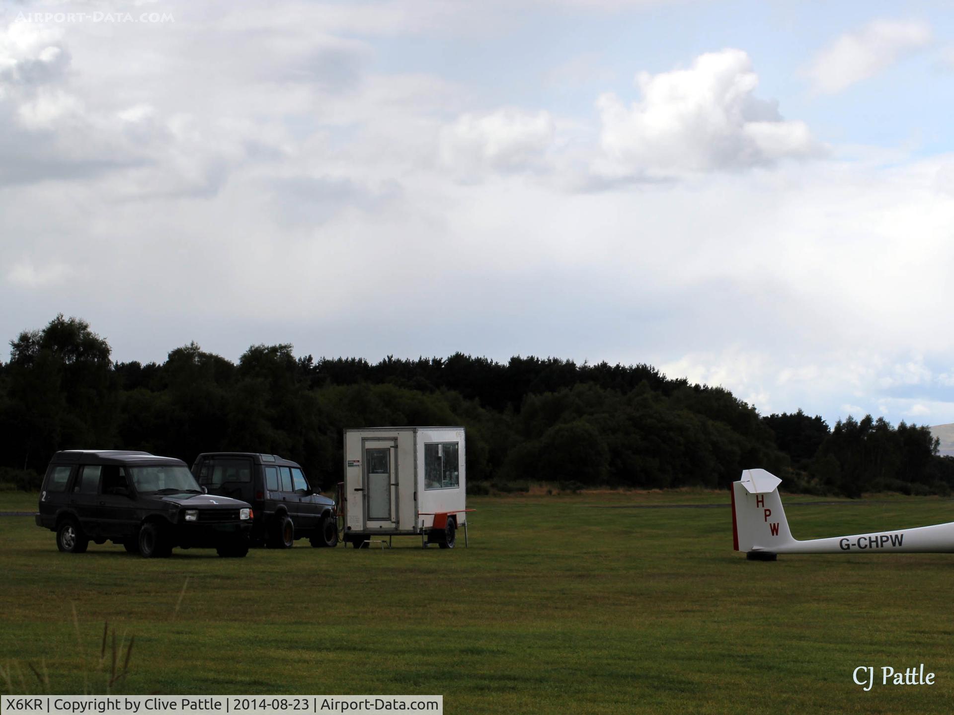 X6KR Airport - Portmoak Gliding Field, Kinross, Scotland. A view of the winch launch control cabin and two Land Rovers fitted with wide tyres for glider recovery.