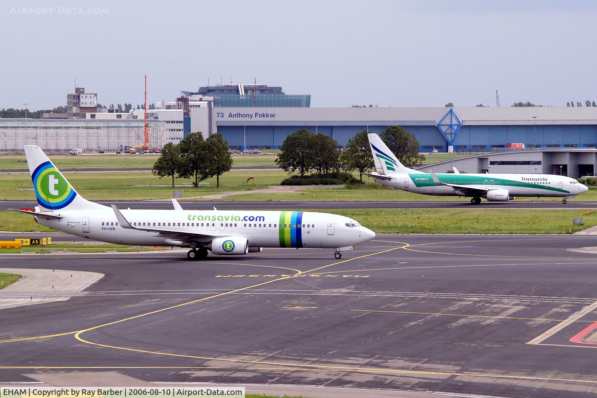 Amsterdam Schiphol Airport, Haarlemmermeer, near Amsterdam Netherlands (EHAM) - Showing new and old Transavia scheme.