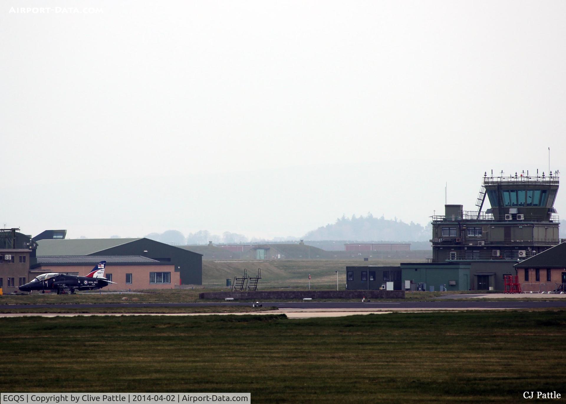 RAF Lossiemouth Airport, Lossiemouth, Scotland United Kingdom (EGQS) - Shot of the tower on a dull, misty and overcast morning at RAF Lossiemouth. A visiting Royal Navy Hawk T.1 sits awaiting its next sortie during the ongoing Exercise Joint Warrior 14-2