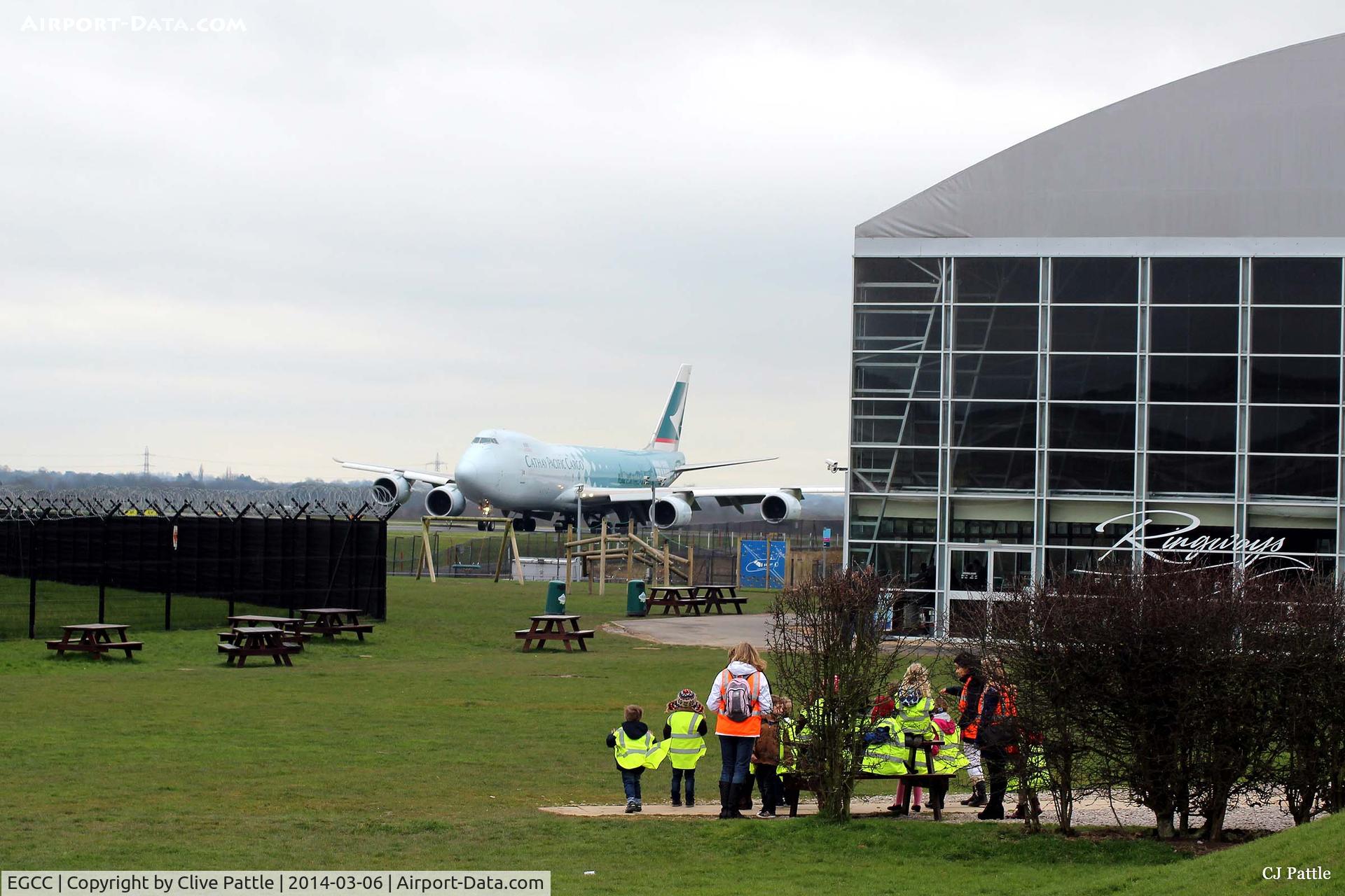 Manchester Airport, Manchester, England United Kingdom (EGCC) - A view of the Runways Restaurant and Concorde hangar at Manchester Airport EGCC viewing area, highlighting its close proximity to the aircraft, in this case a B747-867F Cargo plane of Cathay Pacific.