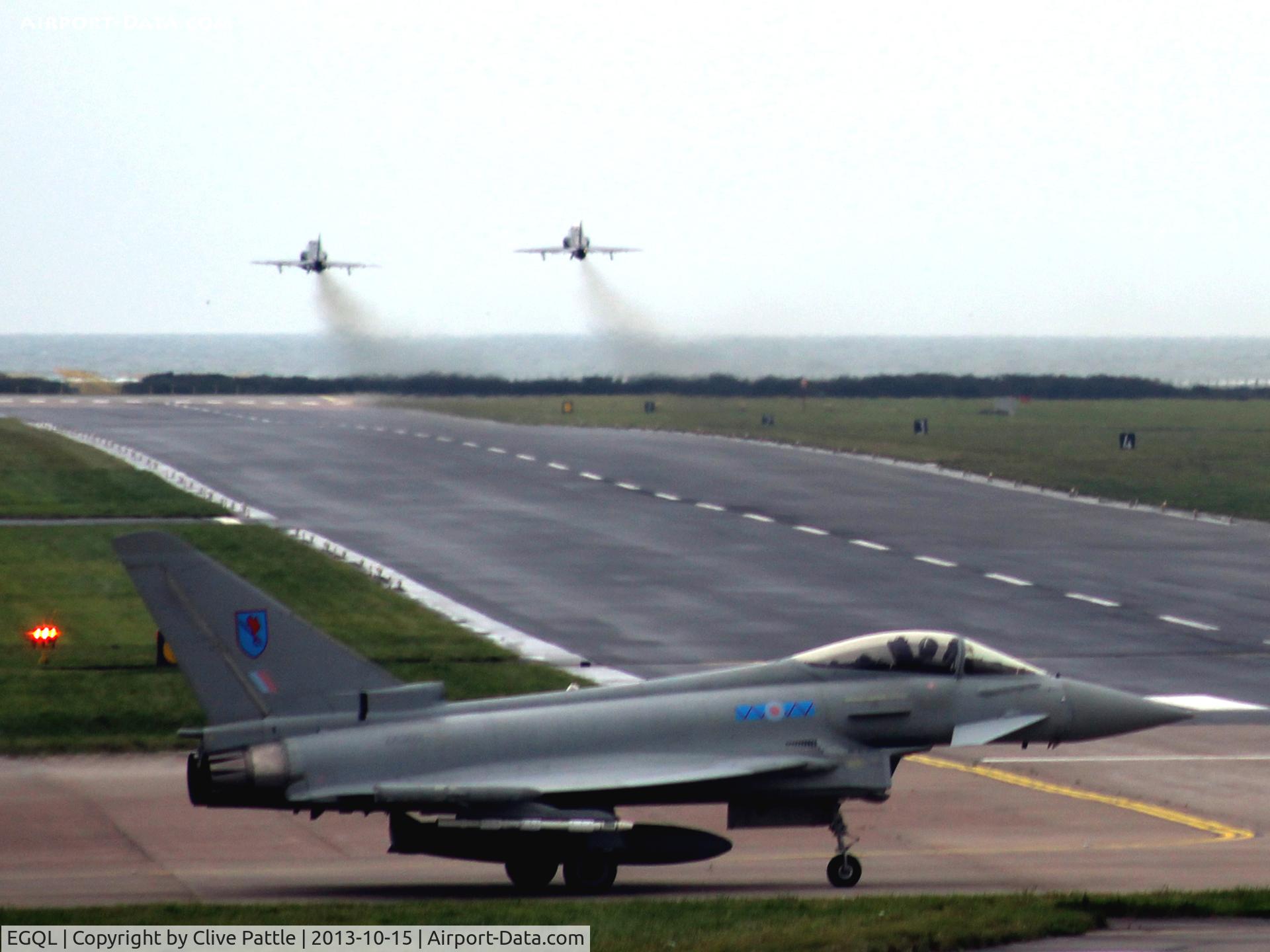 RAF Leuchars Airport, Leuchars, Scotland United Kingdom (EGQL) - A shot down runway 09 at RAF Leuchars with a based 6 Sqn Typhoon FGR.4 waiting for the twin 100 Sqn Hawks to clear. In the distance the North Sea is visible.