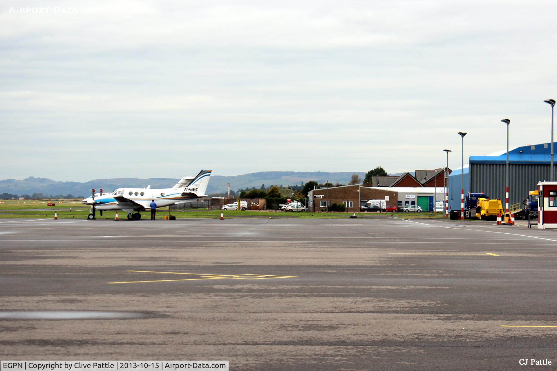 Dundee Airport, Dundee, Scotland United Kingdom (EGPN) - Wide expanse of apron available at Dundee Riverside. In the distance, looking west,  is a visiting M-KING and on the right the Loganair/Flybe maintenance hangar is visible