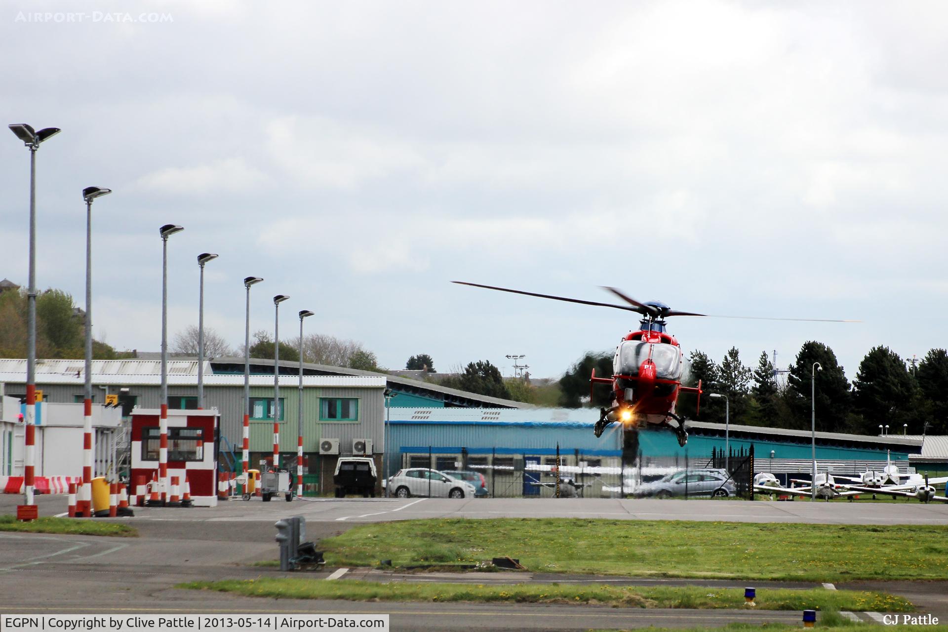 Dundee Airport, Dundee, Scotland United Kingdom (EGPN) - Eastwards facing shot of the apron at Dundee EGPN with a Northern Lighthouse EC135 (G-CGPI) hovering to land.