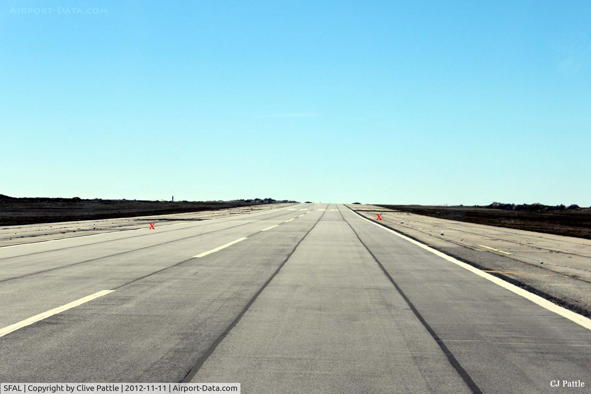 SFAL Airport - A view down the main runway at Port Stanley facing west. I have marked with red crosses the site of two Bomb repair areas on the runway, remnants of the Vulcan Black Buck attacks in May 1982
