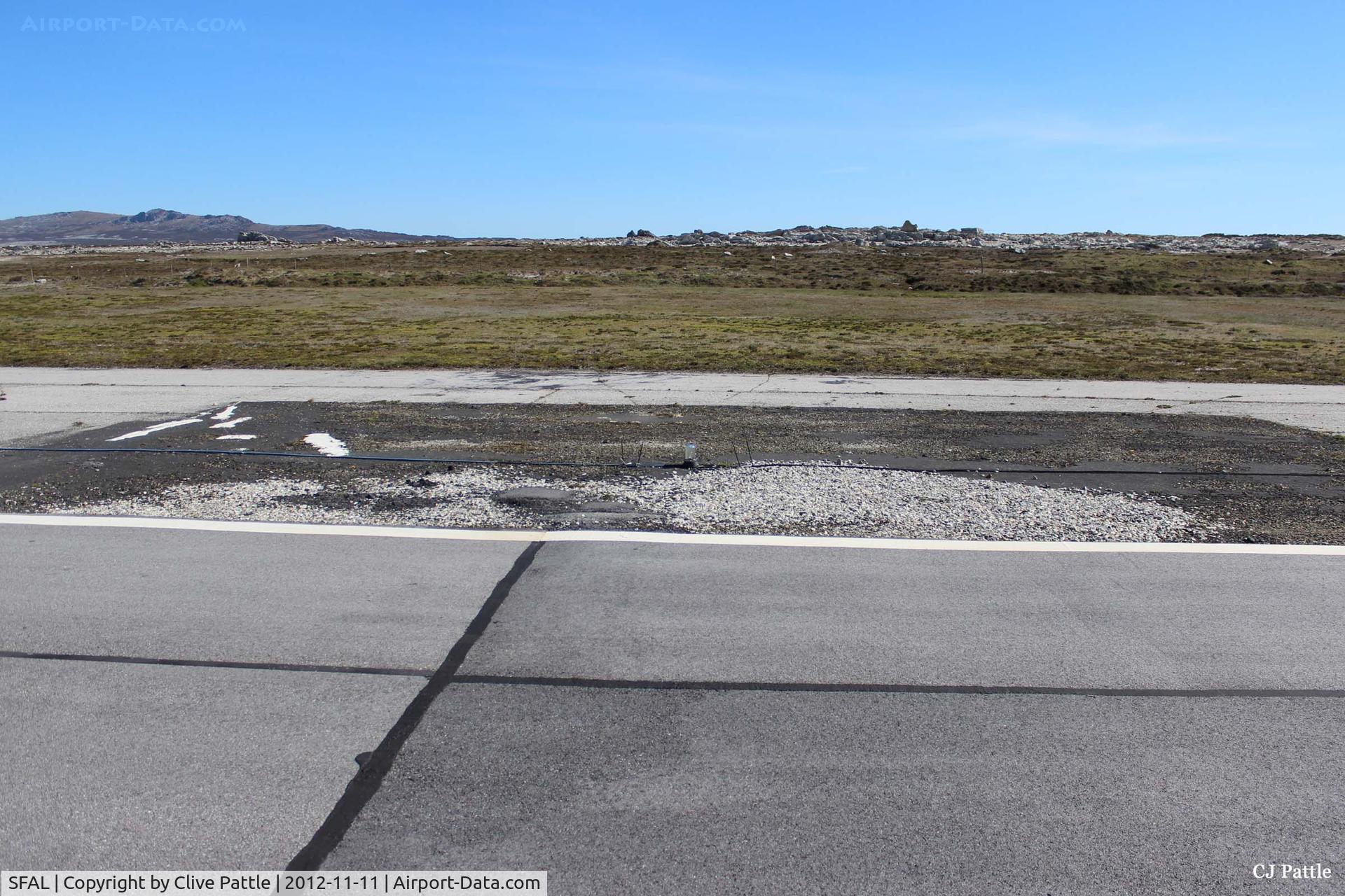 SFAL Airport - A darkened area of tarmac on the edge of the main runway at Port Stanley (SFAL) shows where repairs were made following the Vulcan Black Buck bombing sortie in May 1982. 