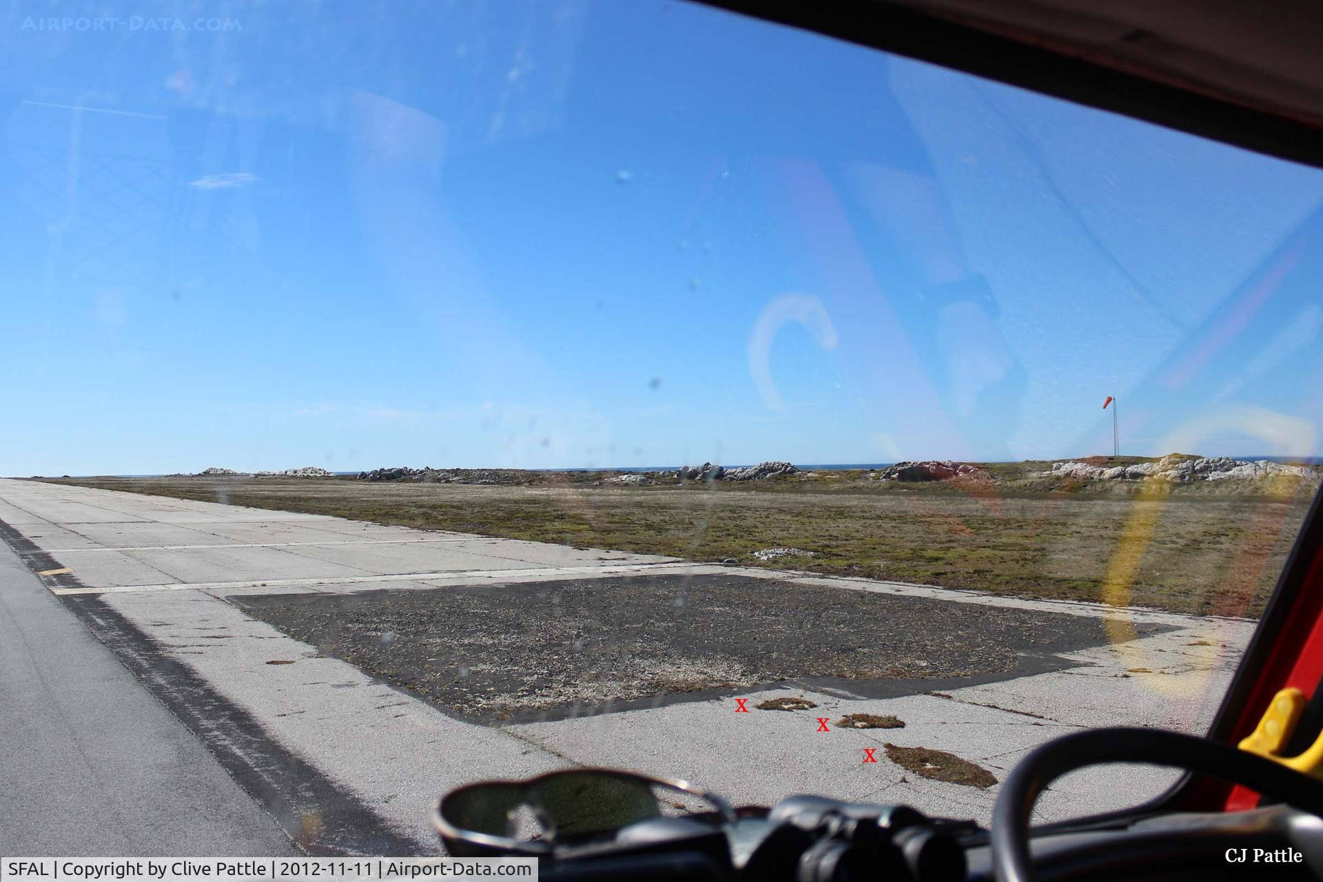 SFAL Airport - The tarmac square on the edge of the main runway at Port Stanley (SFAL) shows the repairs following the Vulcan bombing in May 1982. Area subjected to subsidence ever since.