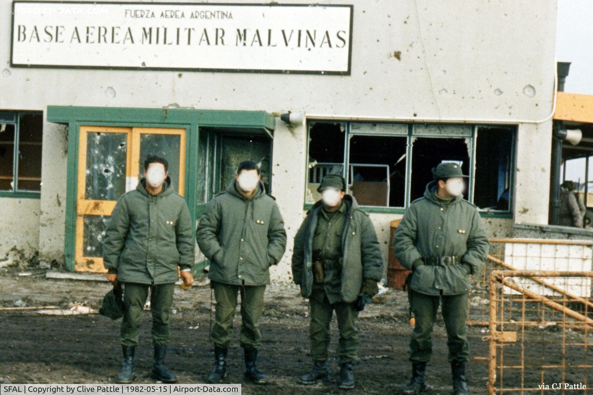 SFAL Airport - A Falklands War image from May 1982 with Argentinian Officers standing in front of the main airport terminal at Stanley SFAL. The building shows signs of damage, from RAF Black Buck Vulcan raids and Harrier GR.3 and Sea Harrier FRS.1 strafing attacks.