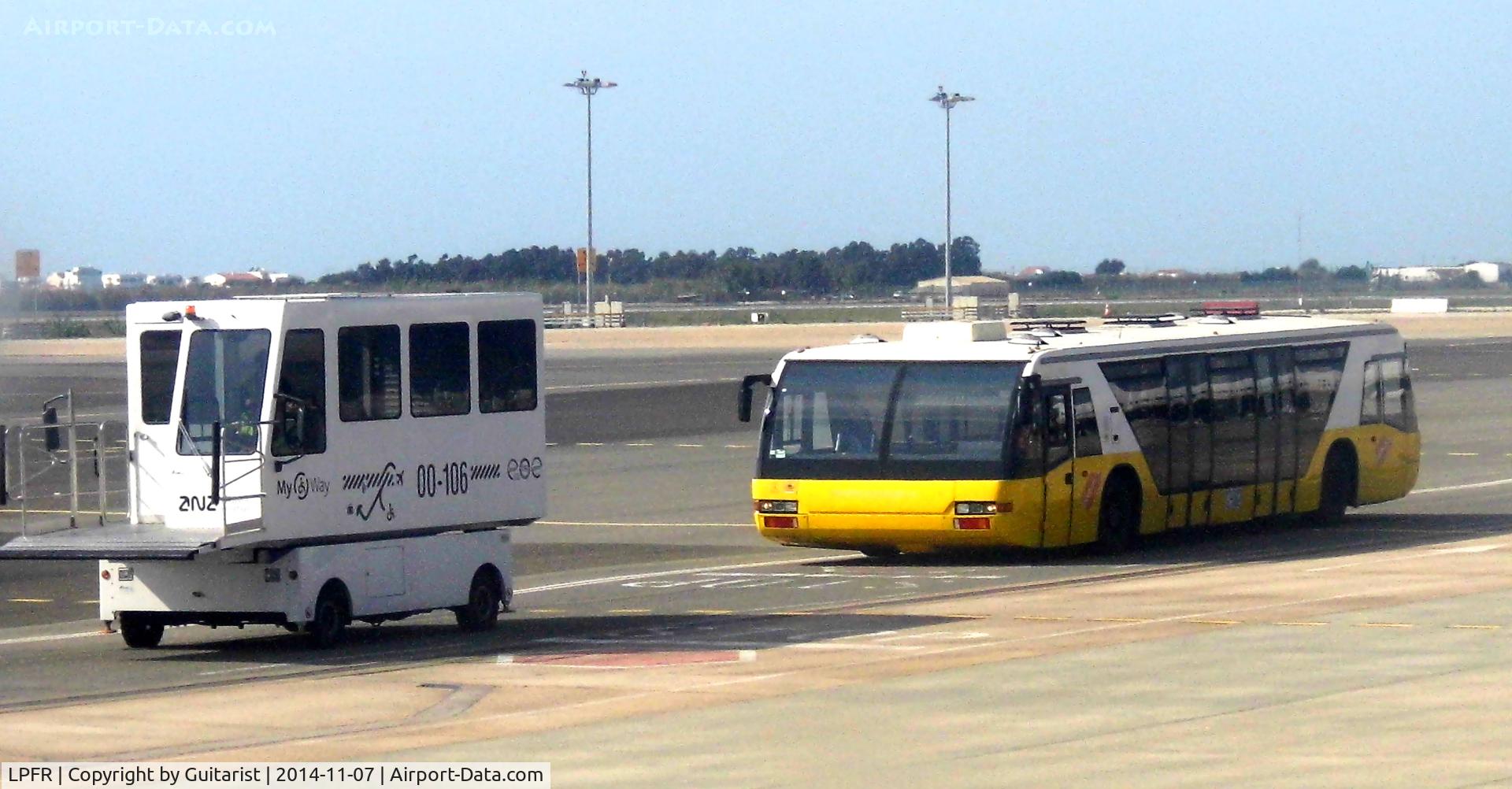 Faro Airport, Faro Portugal (LPFR) - The white vehicle is used for wheelchairs and passengers with mobility issues