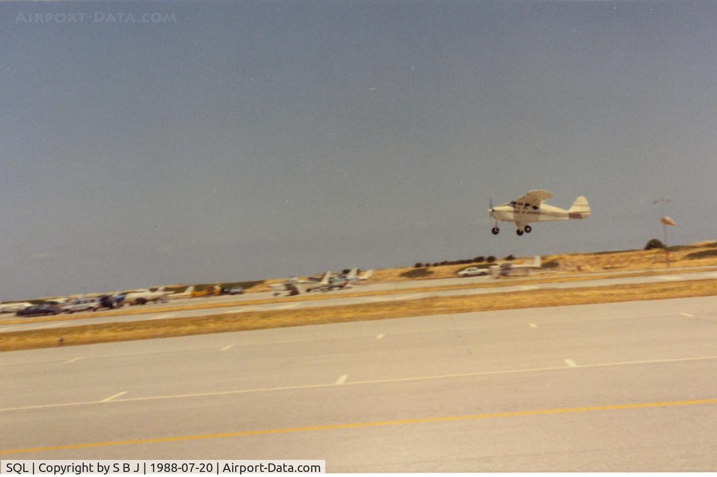 San Carlos Airport (SQL) - N2371P crabbing on takeoff at San Carlos airport in a typical summer afternoon wind condition.Notice windsock behind 71P.Better brush up on crosswinds if you fly out of San Carlos. The wind is most often as seen due to the cool coast  and warm valley east