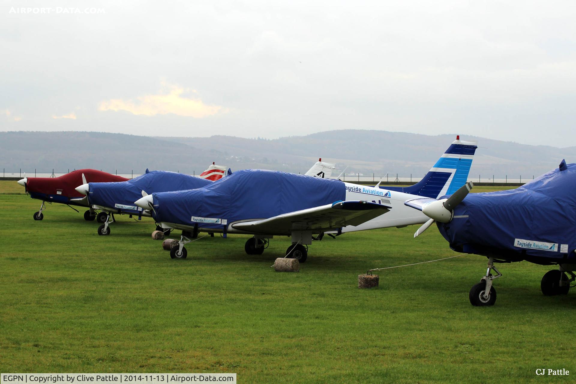 Dundee Airport, Dundee, Scotland United Kingdom (EGPN) - A line-up of PA-28's of Tayside Aviation at Dundee Riverside, wrapped in their protection for winter.