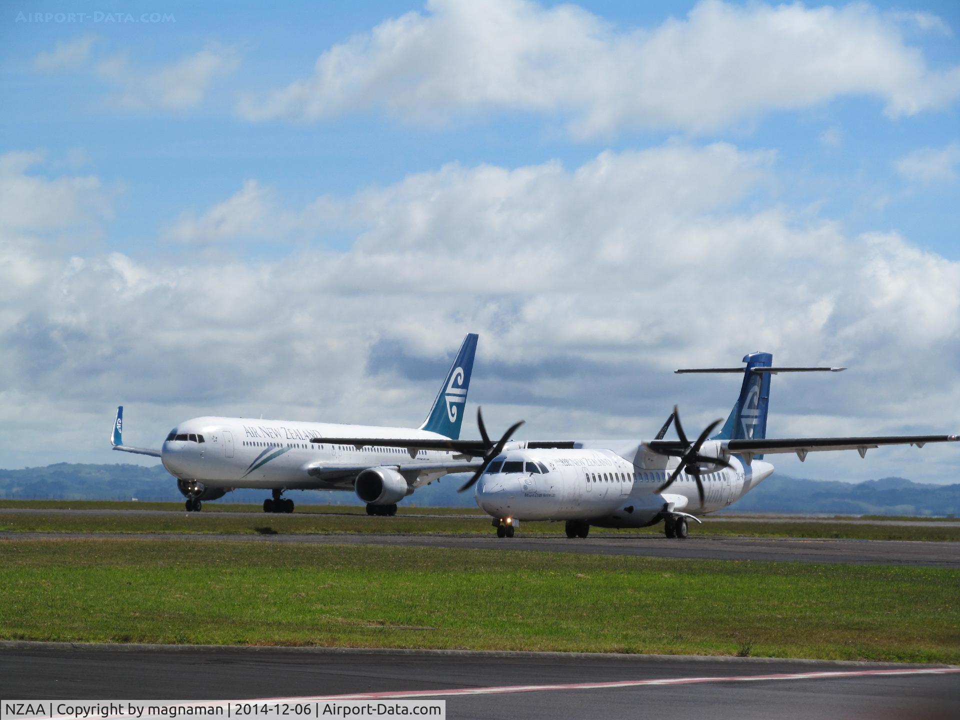 Auckland International Airport, Auckland New Zealand (NZAA) - ZK-NCJ and ZK-MCU racing along taxyway