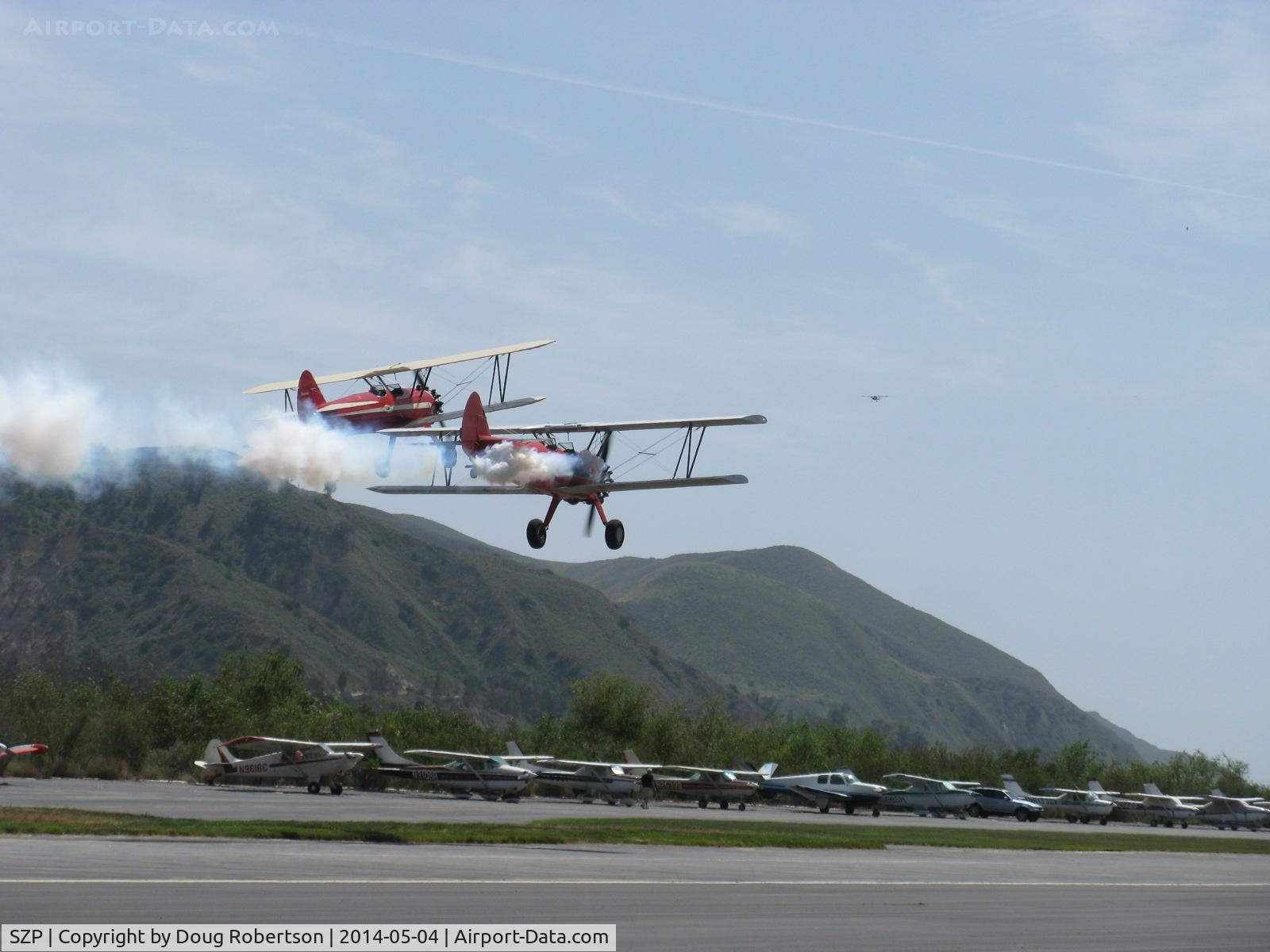Santa Paula Airport (SZP) - Aviation Museum of Santa Paula 1st Sunday display day, N66711 and N65124 with smoke in echelon making fast low pass over Rwy 22